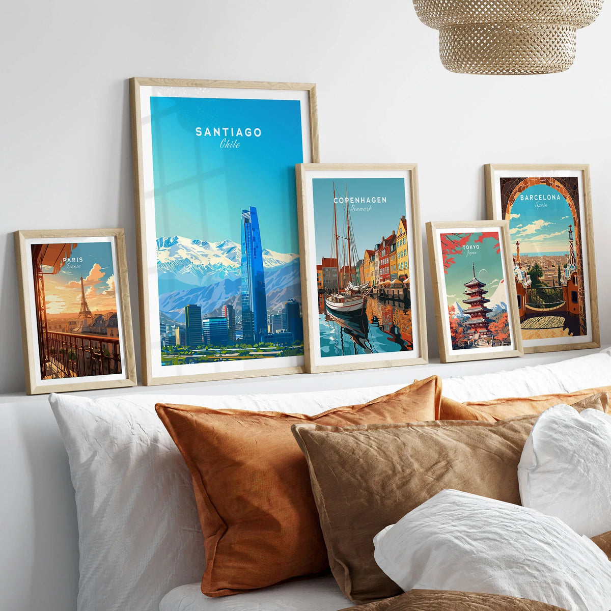 Santiago Travel Poster - Chile in a gallery wall set of five framed travel prints in natural wood frames above a bed