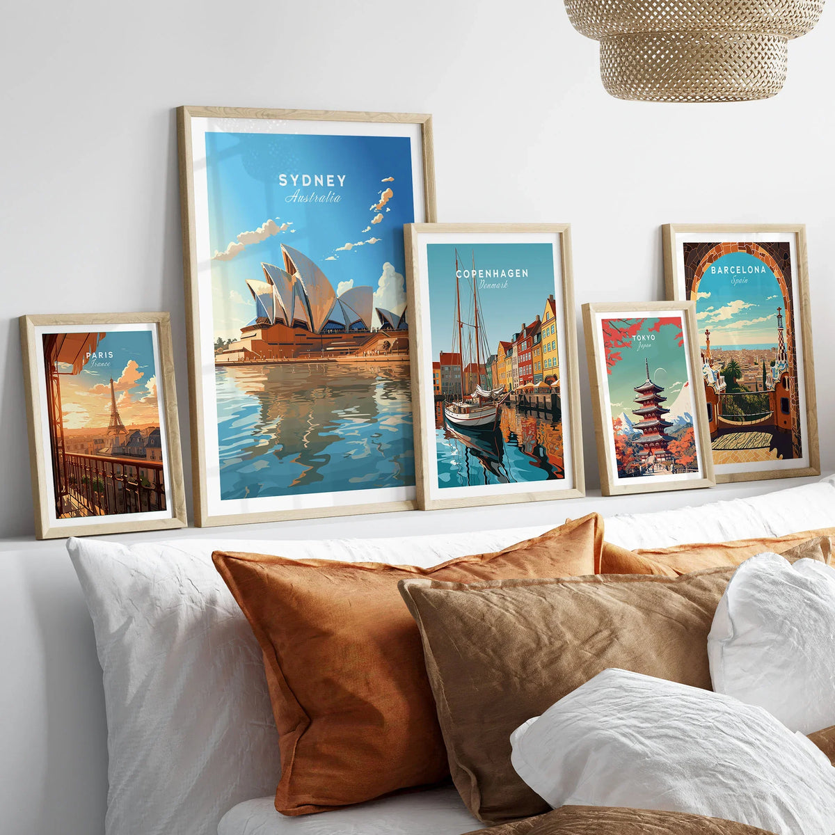 Sydney Poster Australia in a gallery wall set of five framed travel prints in natural wood frames above a bed