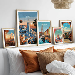 Tangier Morocco Sunset Medina Travel Poster — Tangier medina rooftops and a minaret above a bay dotted with sails, shown as set five framed artprints above bed natural wood frames