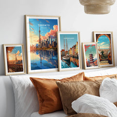 Toronto Poster in a gallery wall set of five framed travel prints in natural wood frames above a bed
