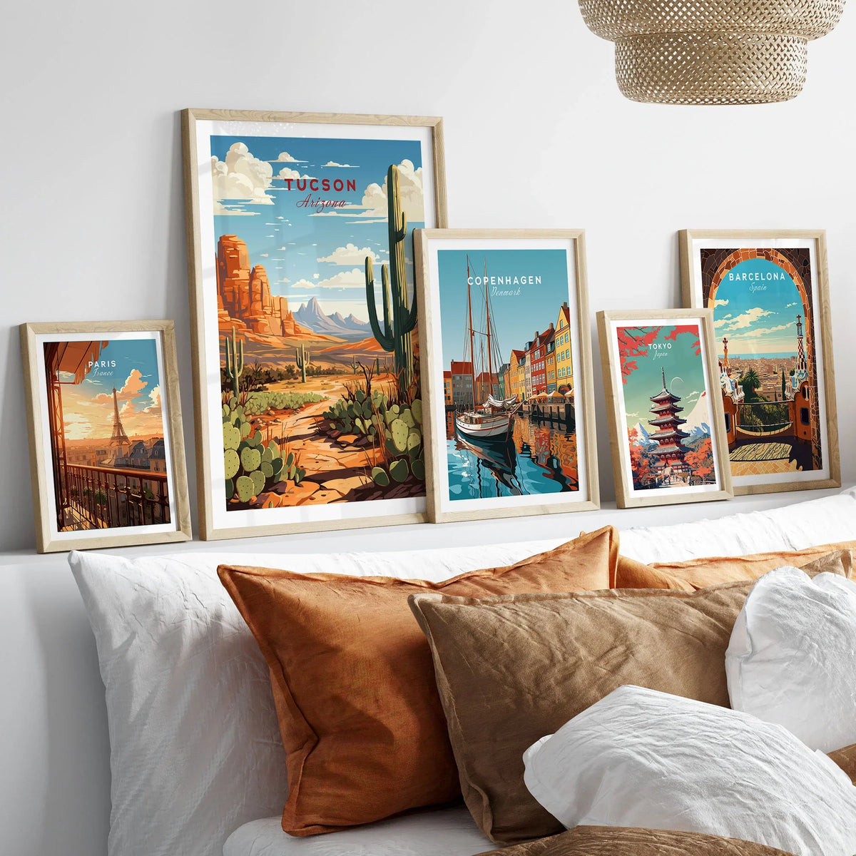 Tucson Arizona Print in a gallery wall set of five framed travel prints in natural wood frames above a bed