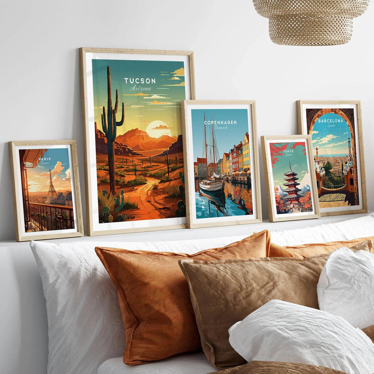 Tucson Arizona Poster in a gallery wall set of five framed travel prints in natural wood frames above a bed