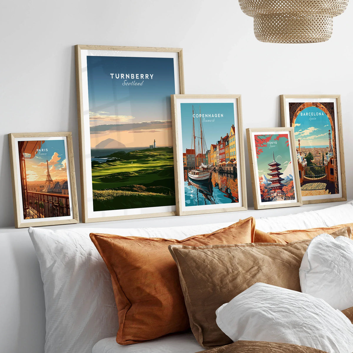 Turnberry Scotland Ailsa Craig Travel Poster — Ailsa Craig and the white lighthouse across rolling coastal turf at dusk, shown as set five framed artprints above bed natural wood frames