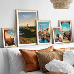 Turnberry Scotland Lighthouse Travel Poster — the Turnberry lighthouse above a rocky shore with the Arran hills beyond, shown as set five framed artprints above bed natural wood frames