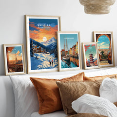 Whistler Poster in a gallery wall set of five framed travel prints in natural wood frames above a bed
