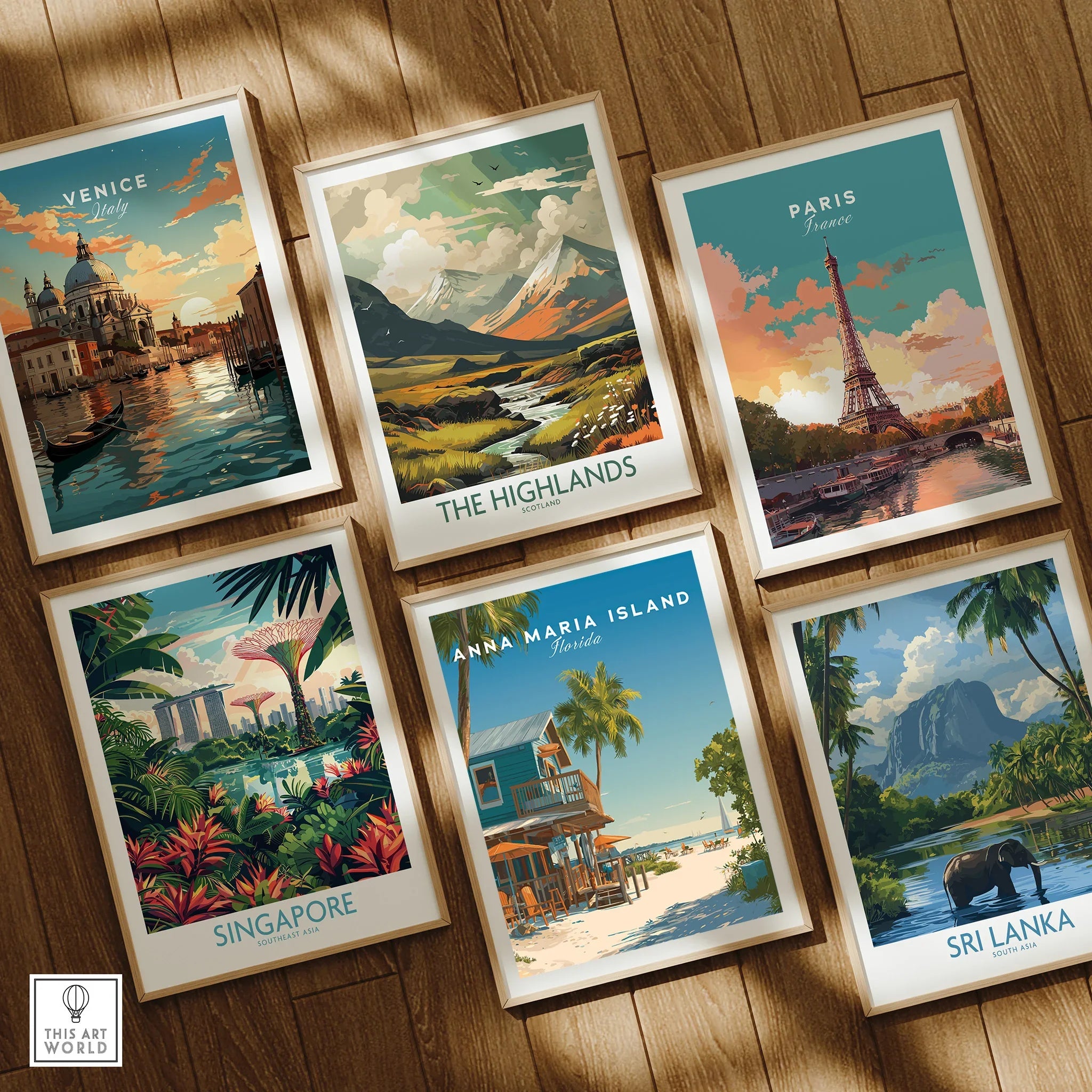 Set of six framed travel posters featuring Venice, Paris, Singapore, Sri Lanka, The Highlands, and Anna Maria Island on a wooden floor.