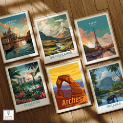 Set of six framed travel art prints on wooden floor, featuring city skylines and nature scenes including Venice, Paris, Singapore, The Highlands, Arches National Park, and Sri Lanka.