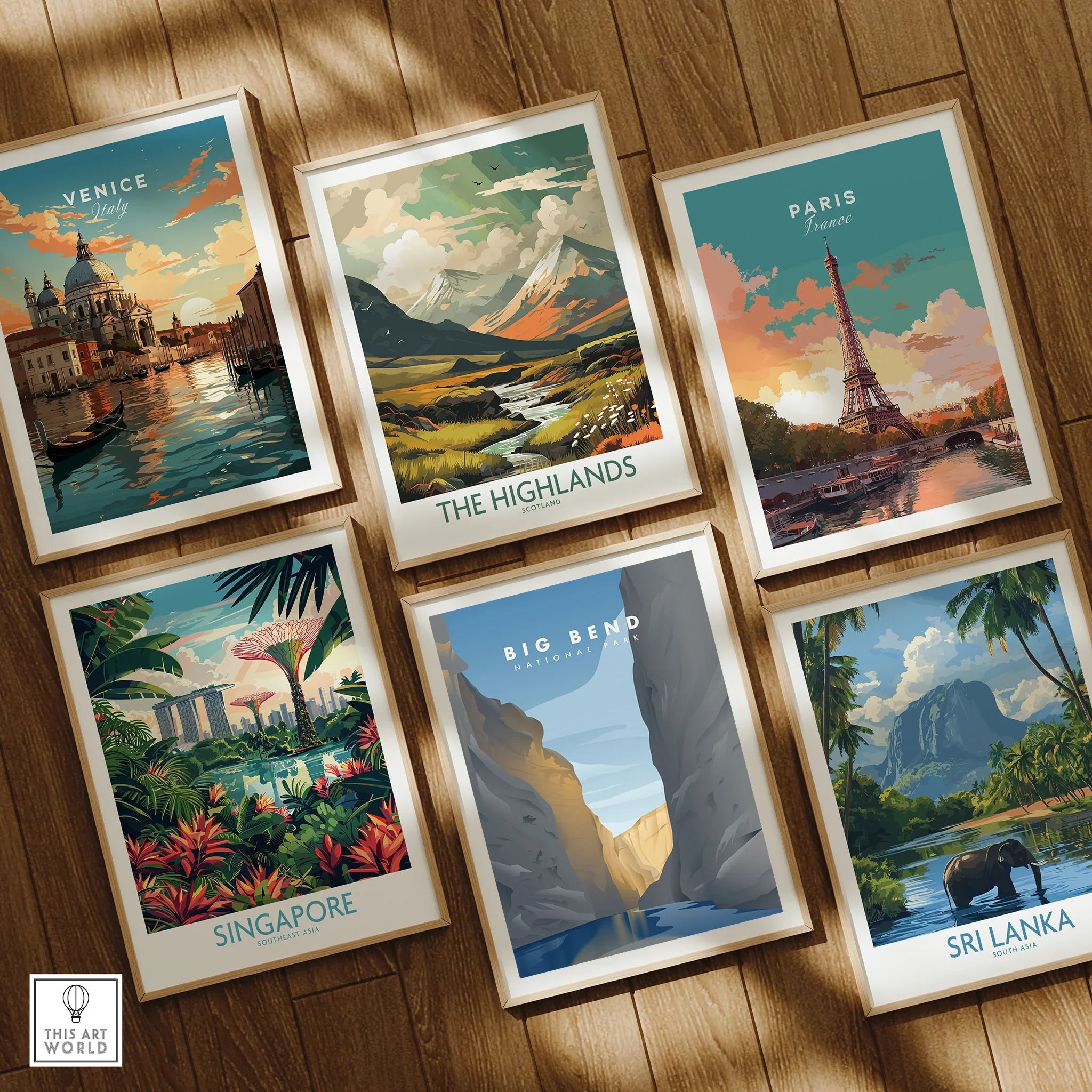 Set of six framed travel art prints featuring Venice, Paris, Scotland, Singapore, Big Bend, and Sri Lanka on a wooden floor.