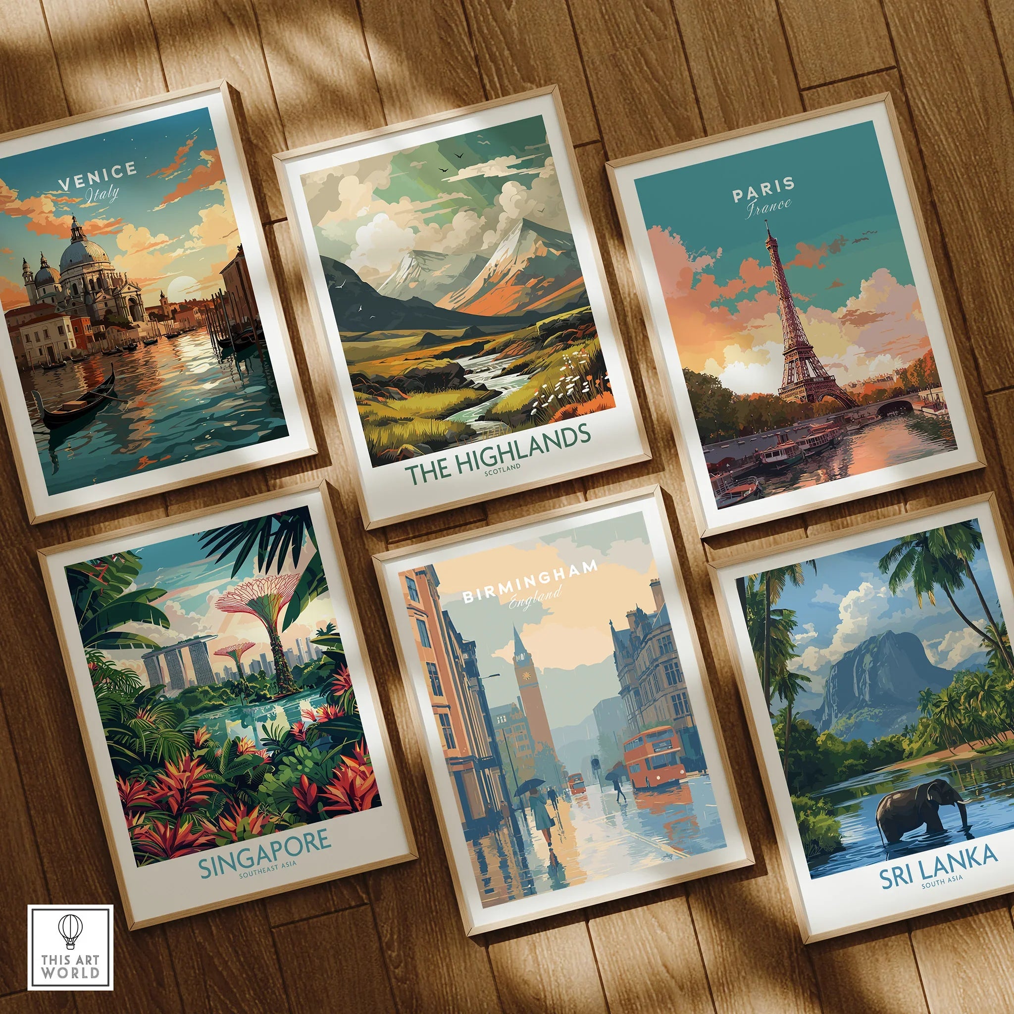 Set of six framed travel art prints featuring Venice, Highlands, Paris, Singapore, Birmingham, and Sri Lanka on a wooden floor.