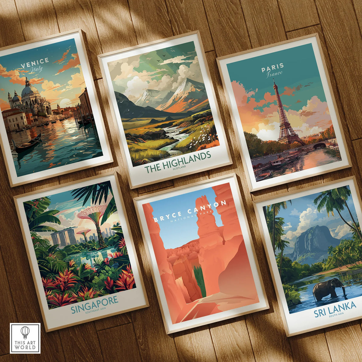 Set of six framed travel posters featuring Venice, Highlands, Paris, Singapore, Bryce Canyon, and Sri Lanka on a wooden floor.