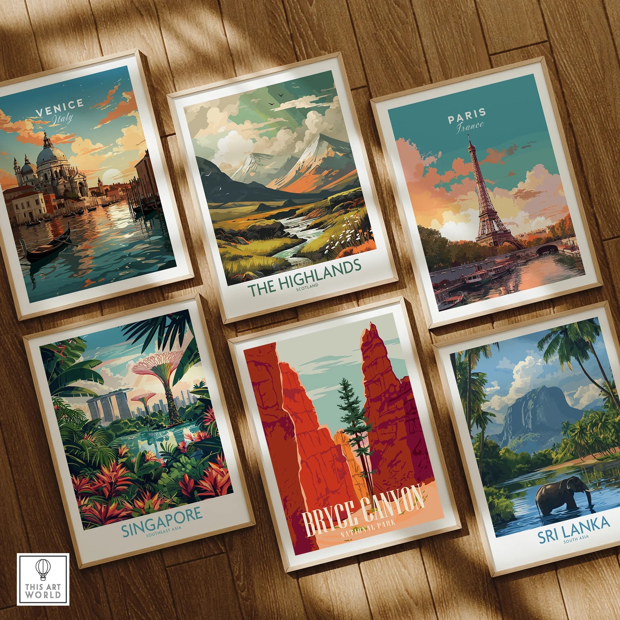 Set of six framed travel art prints featuring Venice, Highlands, Paris, Singapore, Bryce Canyon, Sri Lanka on wooden floor.