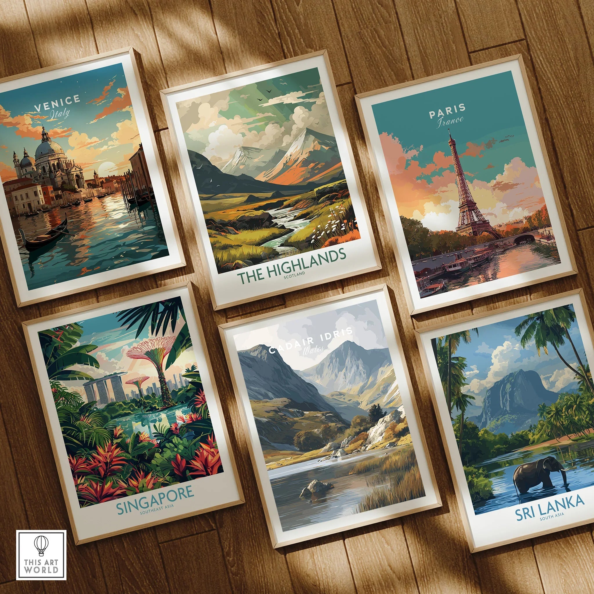 Set of six framed travel art prints featuring Venice, Paris, Singapore, Highlands, Cadair Idris, and Sri Lanka on a wooden floor.