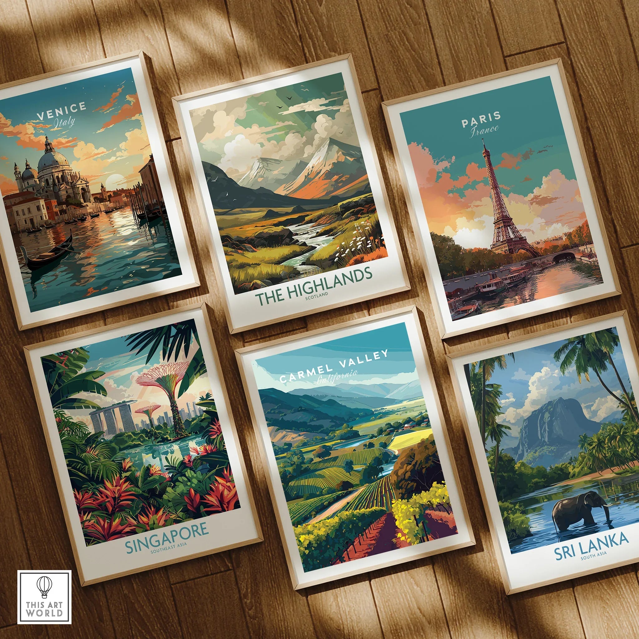 Set of six framed travel art prints featuring Venice, Paris, Highlands, Singapore, Carmel Valley, Sri Lanka on wooden floor.