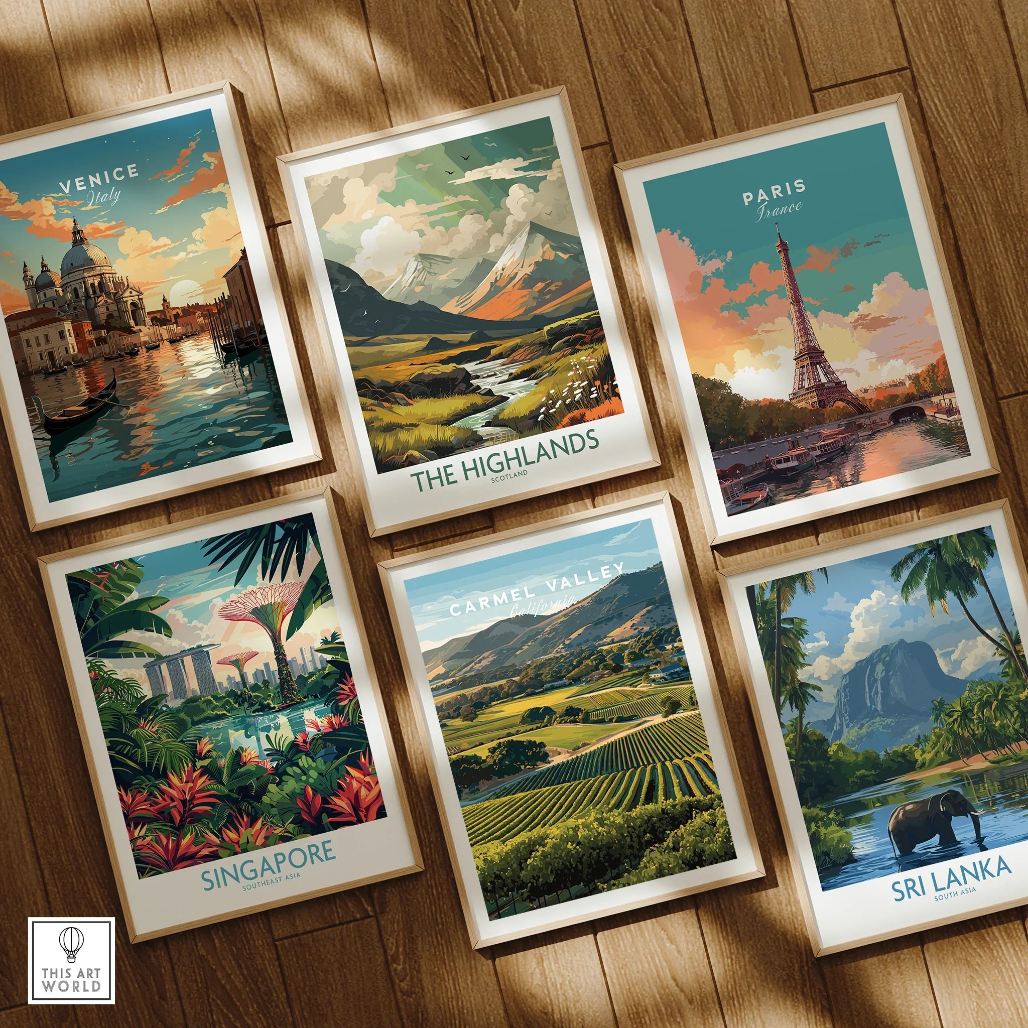 Set of six framed travel art prints featuring Venice, Paris, Singapore, The Highlands, Carmel Valley, and Sri Lanka, displayed on a wooden floor.