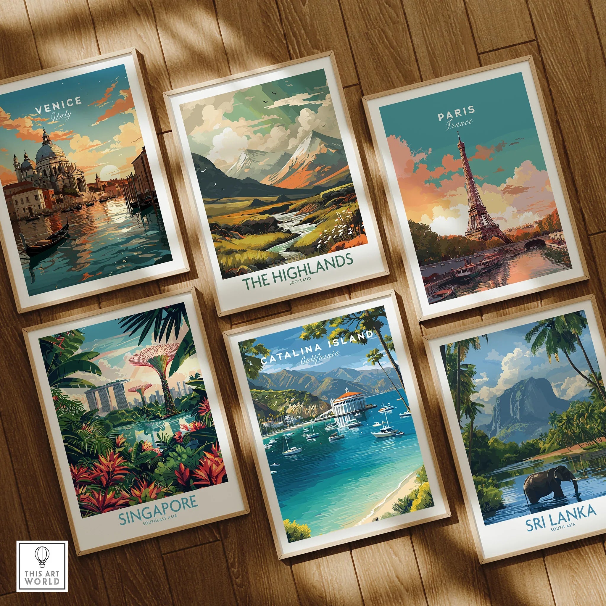 Set of six framed travel art prints featuring Venice, Paris, Singapore, Sri Lanka, Highlands, and Catalina Island, displayed on a wooden floor.