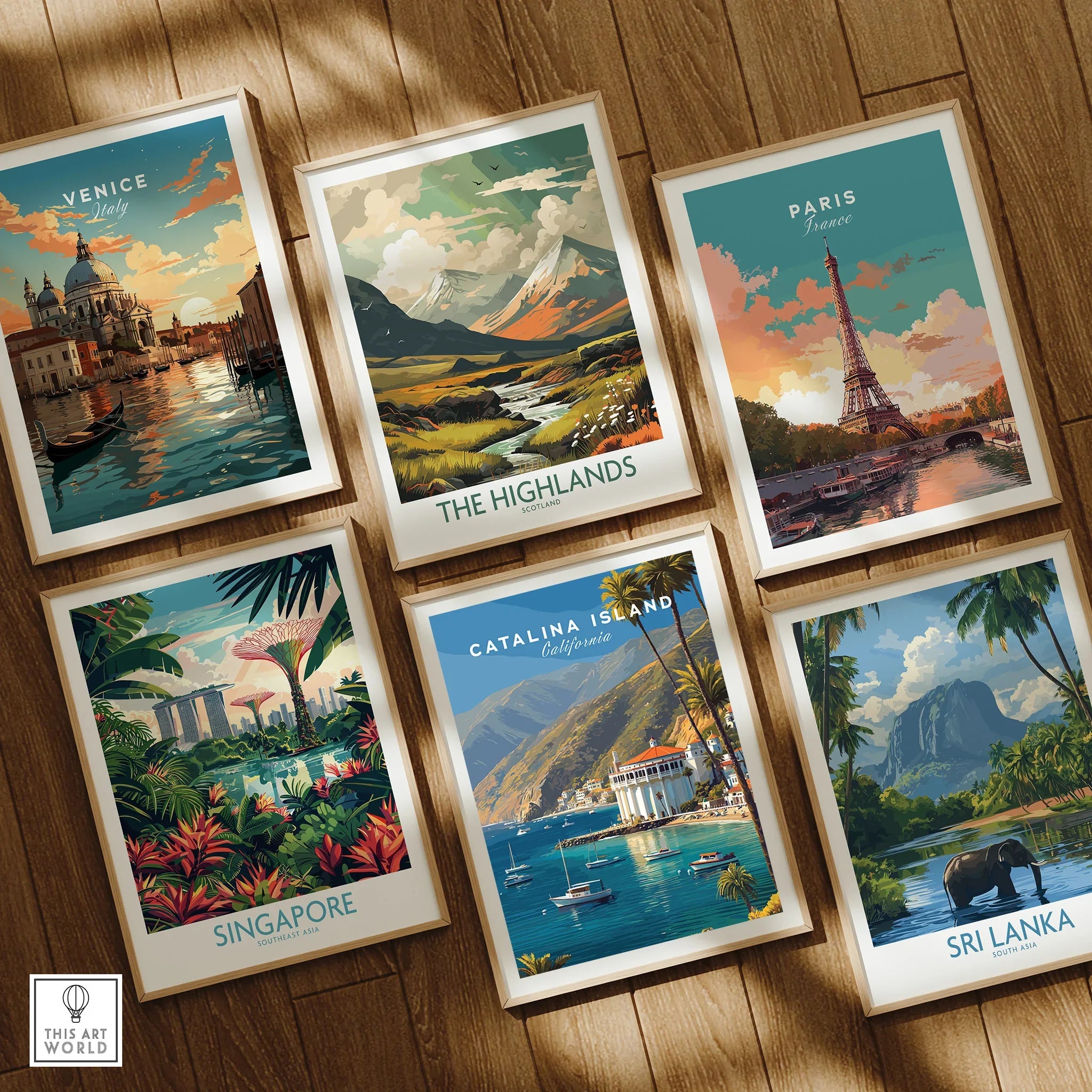 Set of six framed travel posters featuring Venice, Paris, Highlands, Singapore, Catalina Island, and Sri Lanka on a wooden floor.