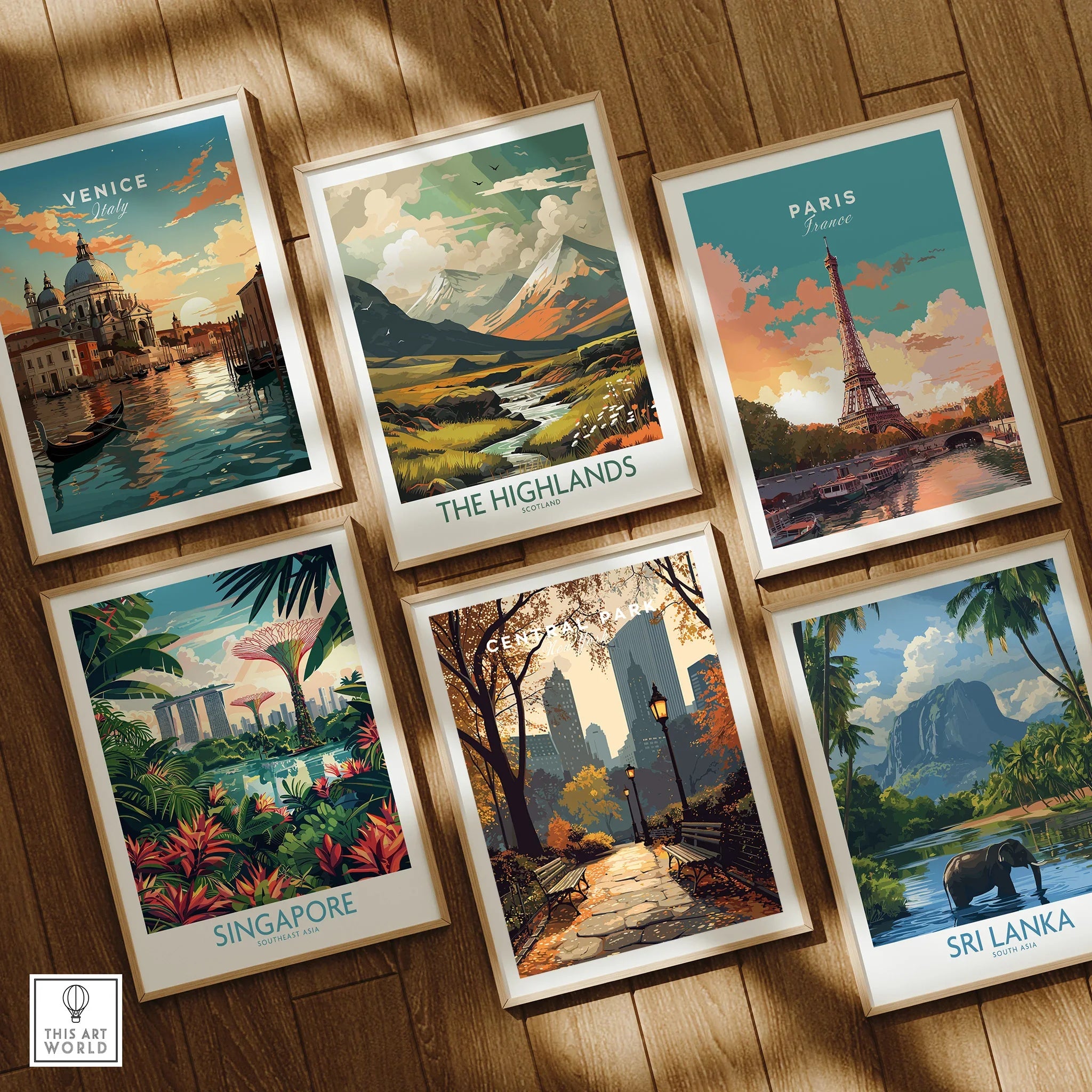 Set of six framed travel art prints featuring Venice, Paris, Central Park, Singapore, The Highlands, and Sri Lanka on a wooden floor.