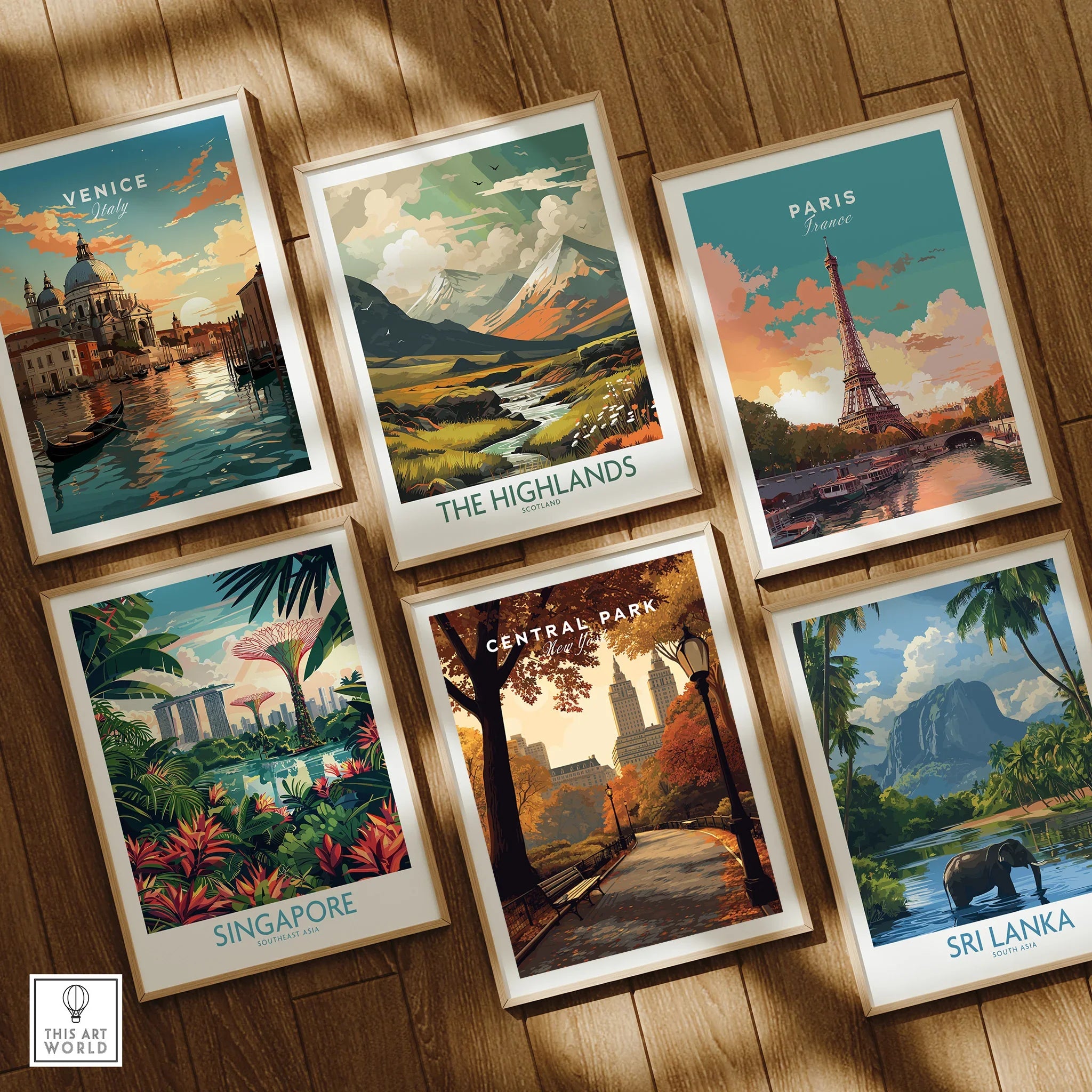 Set of six framed travel art prints on wooden floor, featuring Venice, Paris, Central Park, Singapore, Highlands, and Sri Lanka.
