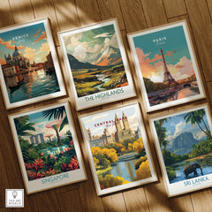 Set of six framed travel art prints featuring Venice, Paris, Central Park, Singapore, Highlands, and Sri Lanka, arranged on a wooden floor.