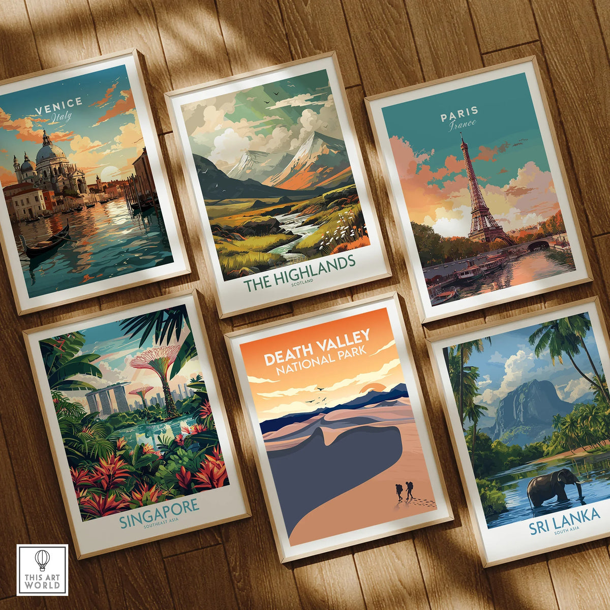 Set of six framed travel posters featuring Venice, Paris, the Highlands, Death Valley, Singapore, and Sri Lanka on a wooden floor.