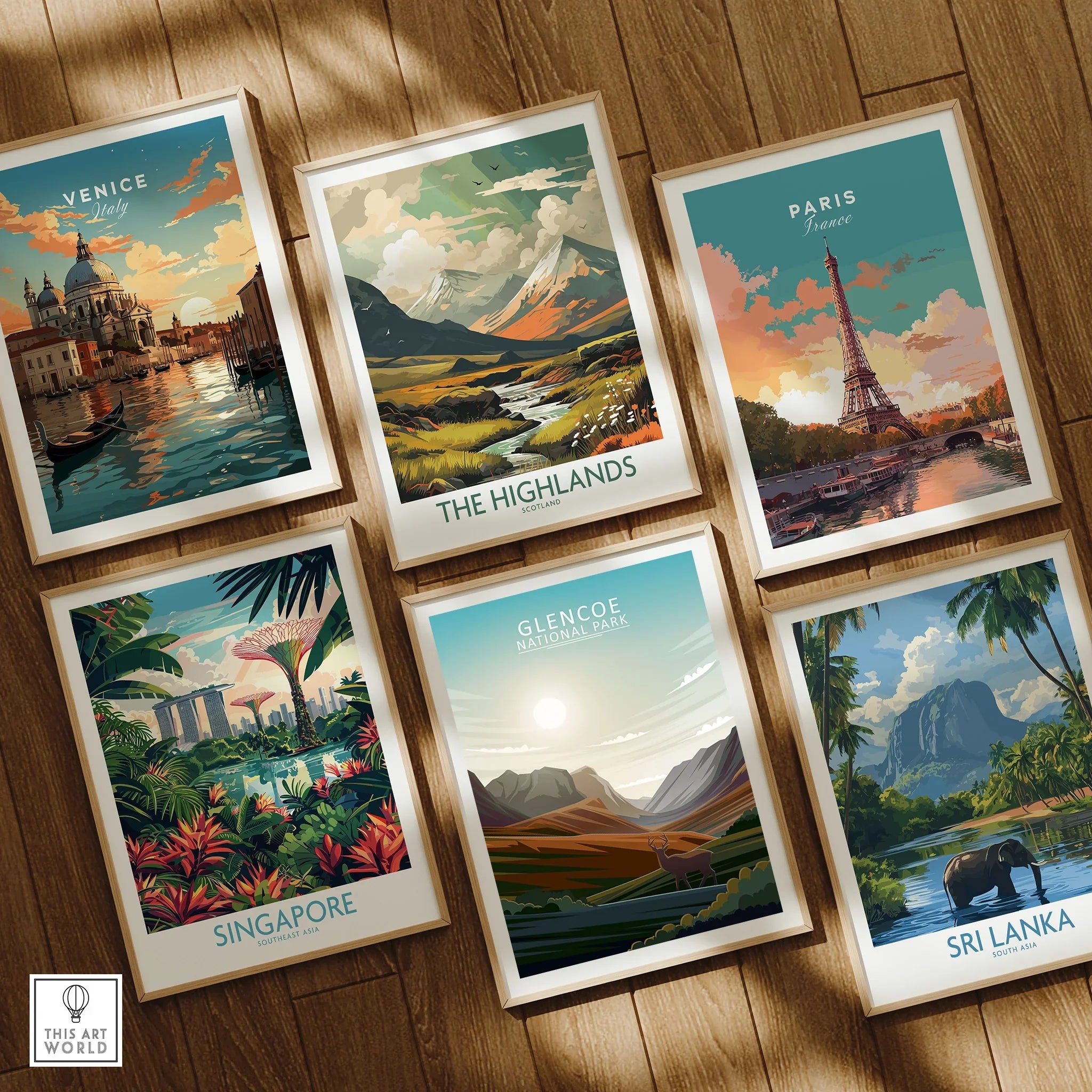 Set of six framed travel posters featuring Venice, Paris, Singapore, Highlands, Glencoe, and Sri Lanka on a wooden floor.