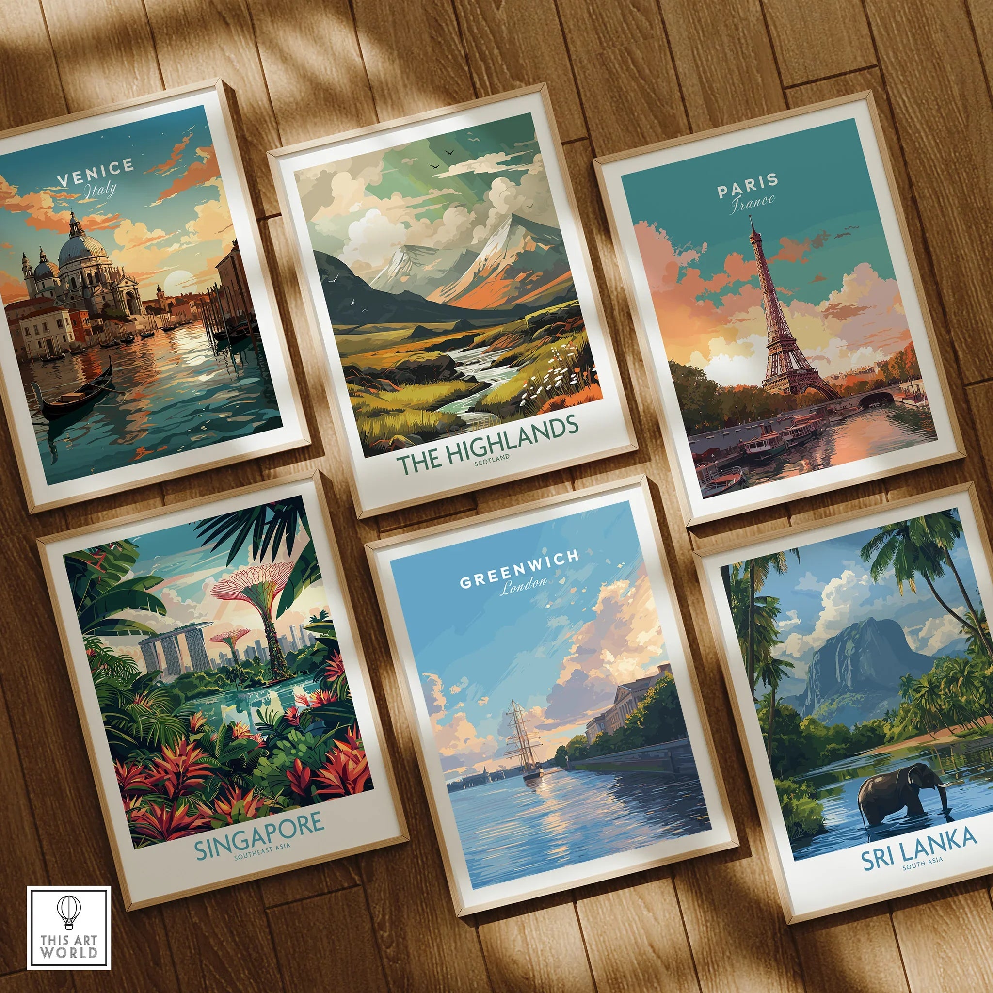 Set of six framed travel art prints featuring Venice, Paris, Greenwich, The Highlands, Singapore, and Sri Lanka on a wooden floor.