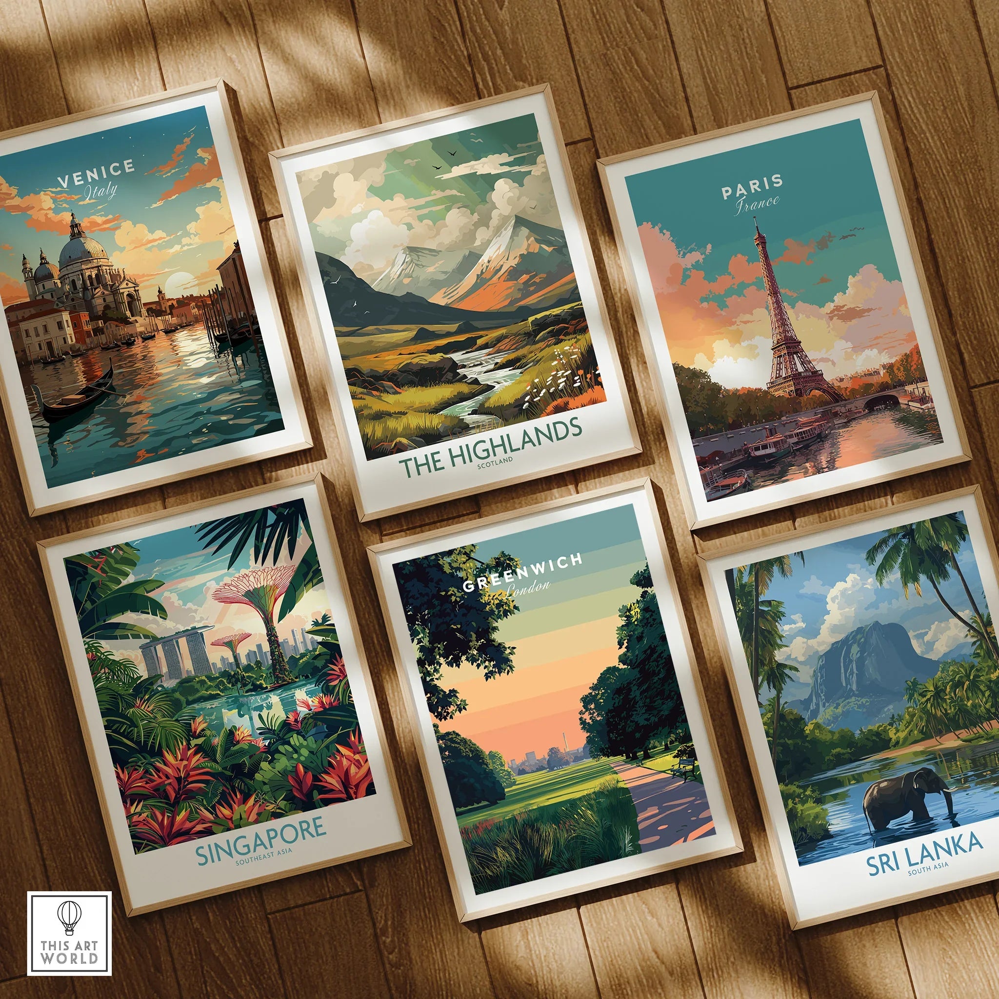 Set of six framed travel art prints, including Venice, Paris, Sri Lanka, Singapore, Greenwich, and The Highlands, displayed on a wooden floor.