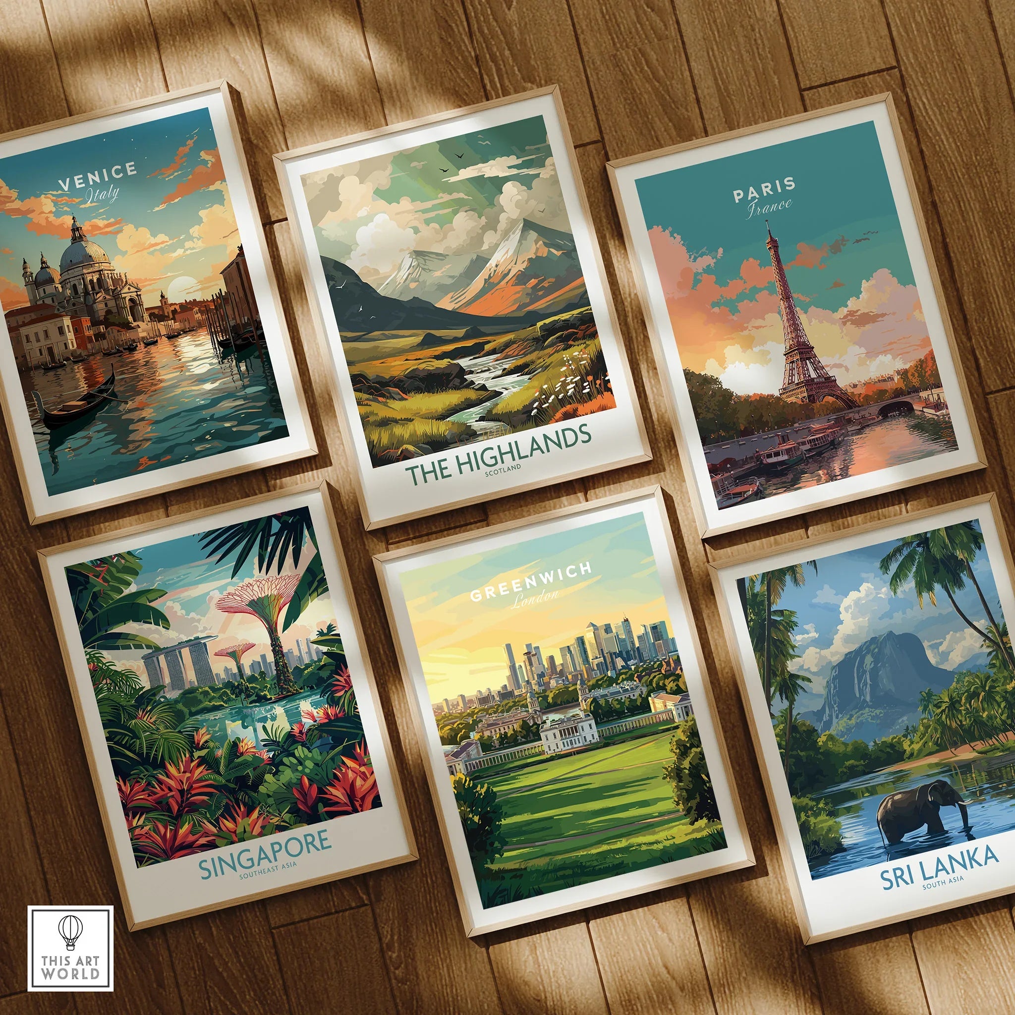 Set of six framed travel art prints featuring Venice, Highlands, Paris, Singapore, Greenwich, and Sri Lanka on a wooden floor.