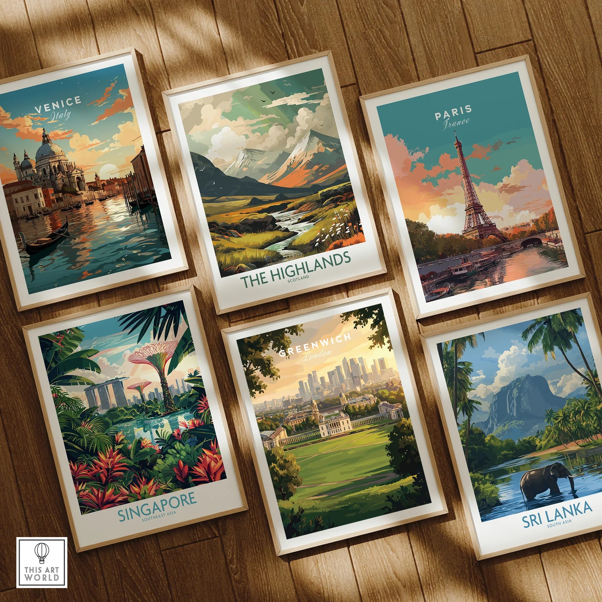 Set of six framed travel art prints showing Venice, Paris, Singapore, Sri Lanka, Highlands, and Greenwich on a wooden floor.