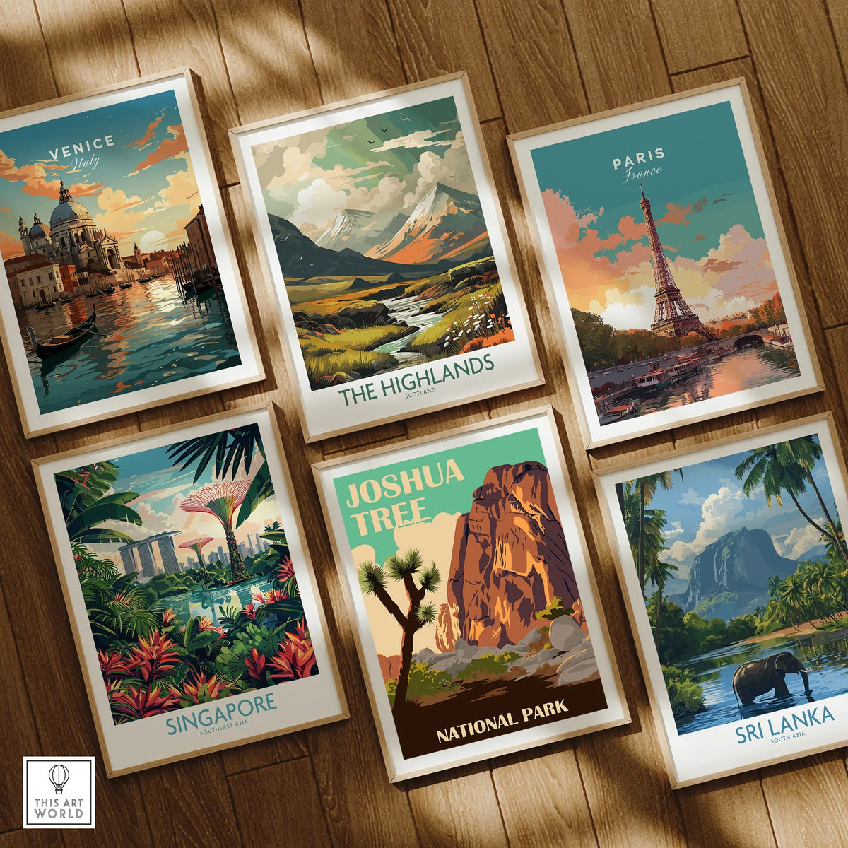 Set of six framed travel art prints featuring Venice, Paris, Singapore, Joshua Tree, the Highlands, and Sri Lanka on a wooden floor.
