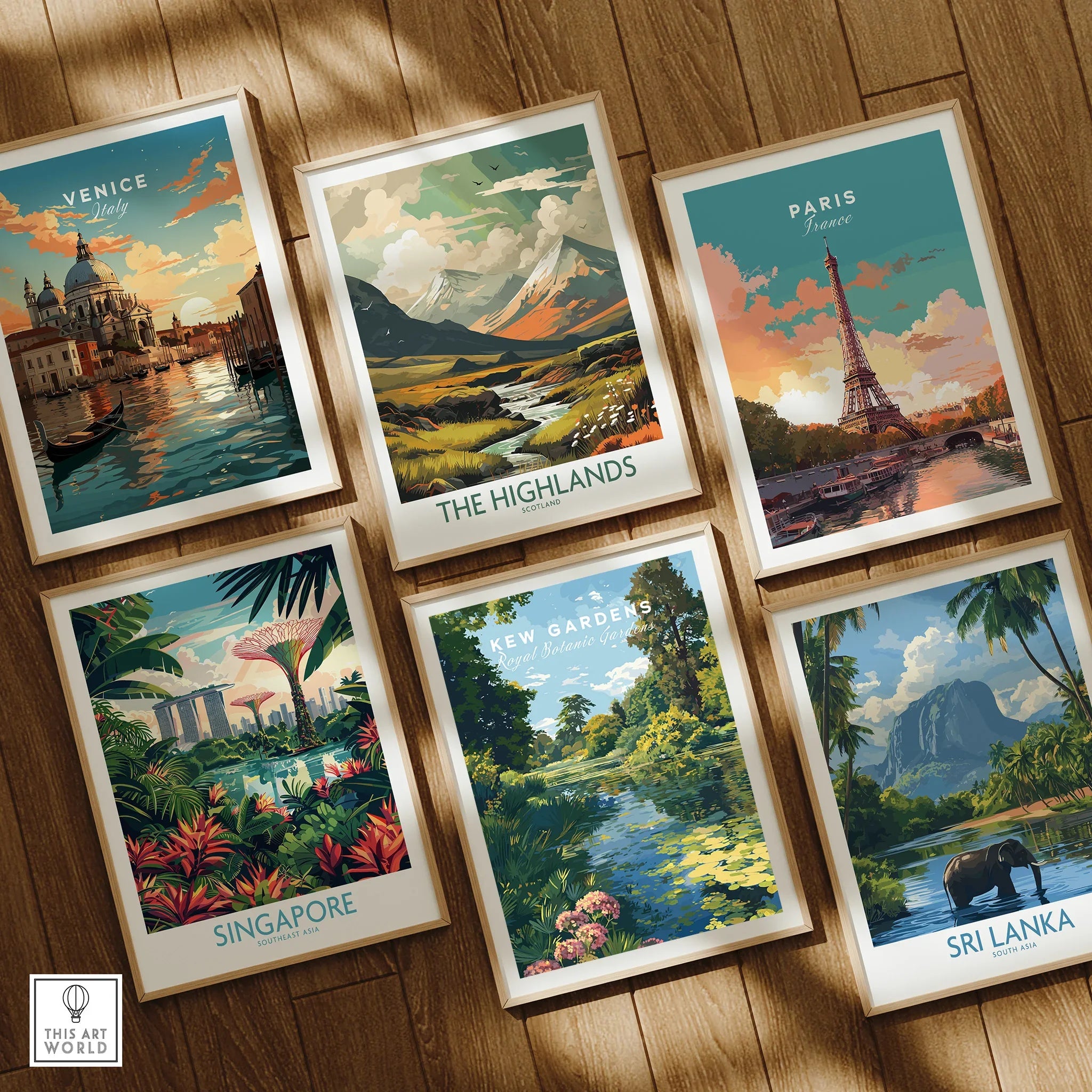 Set of six framed travel art prints on wood floor, featuring Venice, Paris, Highlands, Singapore, Kew Gardens, and Sri Lanka designs.