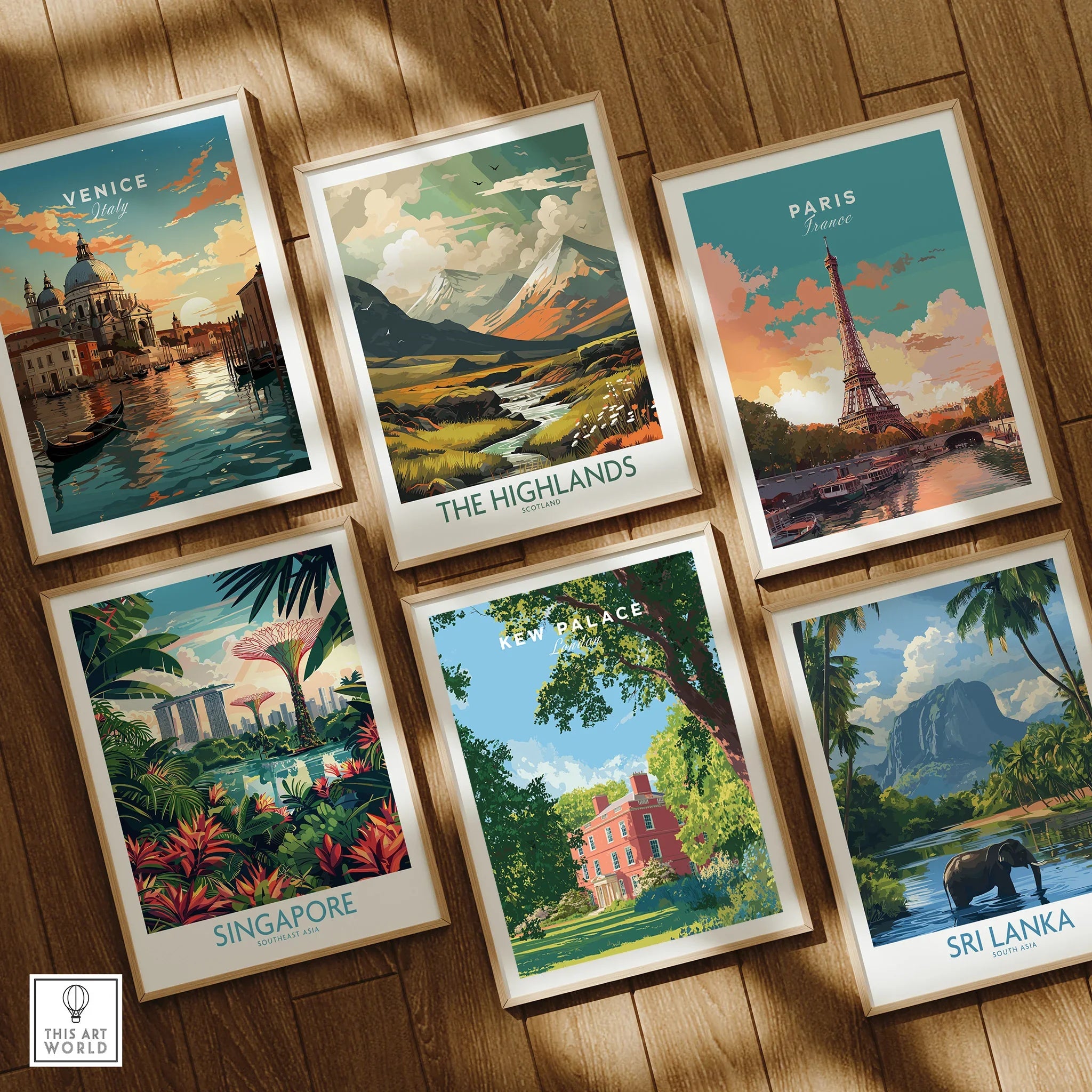 Set of six framed travel posters featuring Venice, Paris, Singapore, Sri Lanka, Kew Palace, and the Scottish Highlands, displayed on a wooden floor.