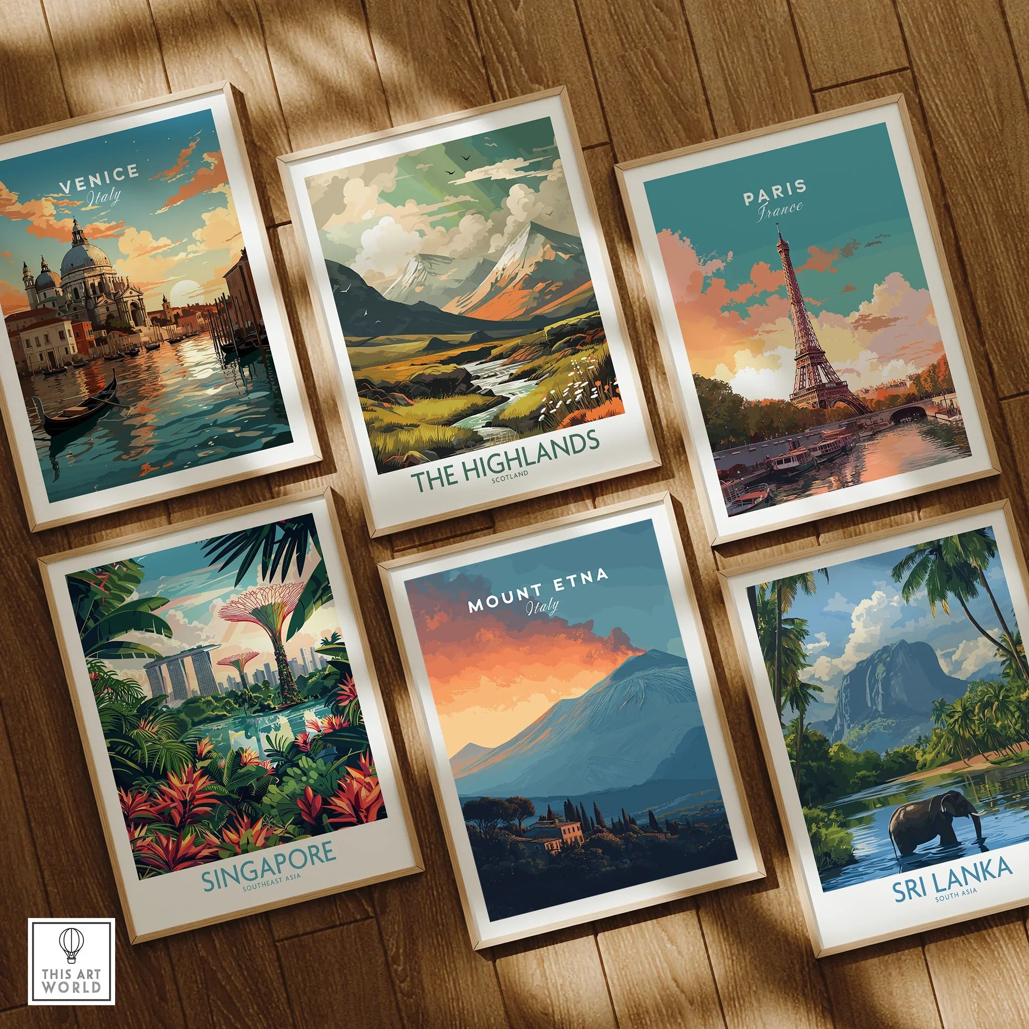Set of six framed travel art prints featuring Venice, Highlands, Paris, Singapore, Mount Etna, and Sri Lanka on a wooden floor.
