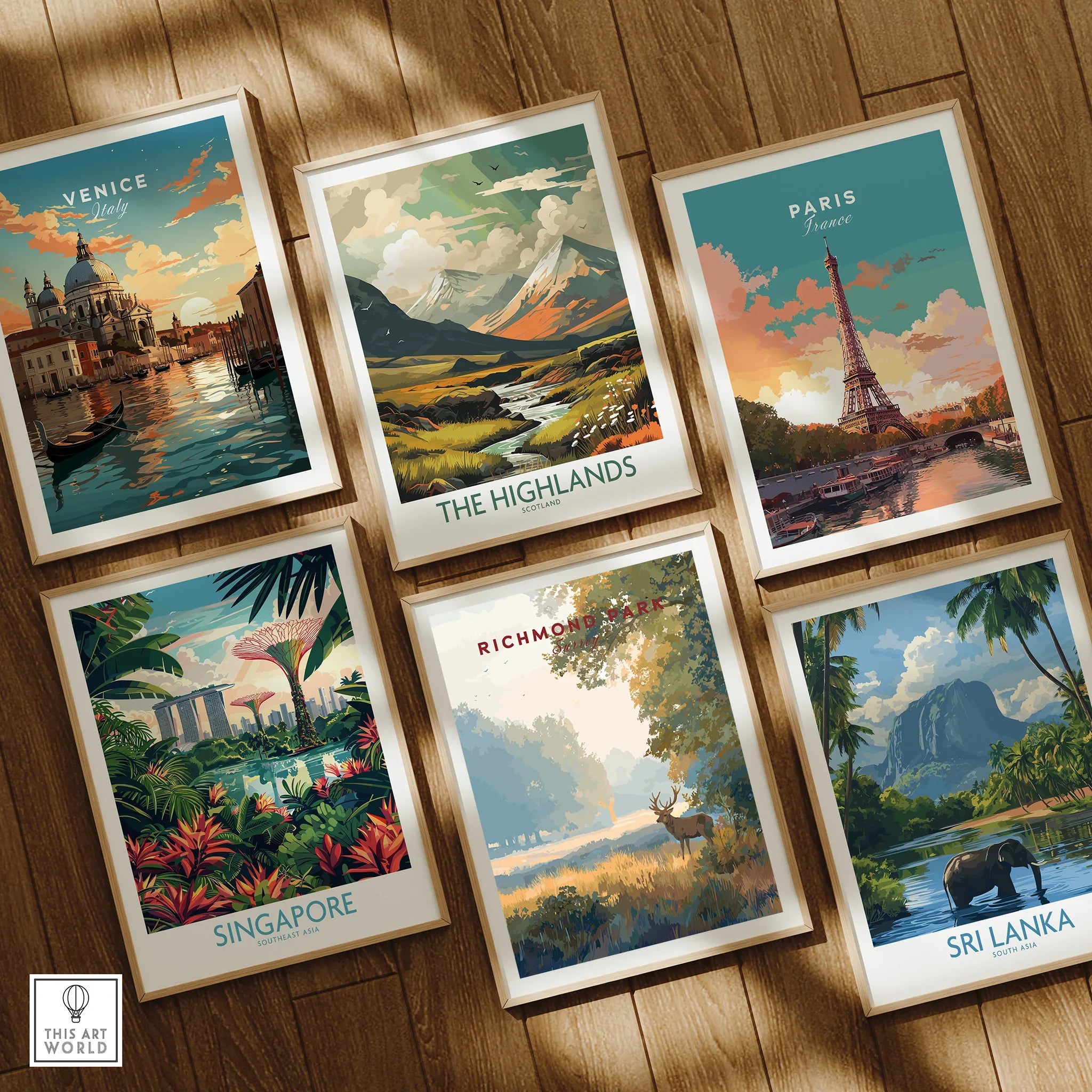 Set of six framed travel art prints featuring Venice, Paris, The Highlands, Singapore, Richmond Park, and Sri Lanka, displayed on a wooden floor.