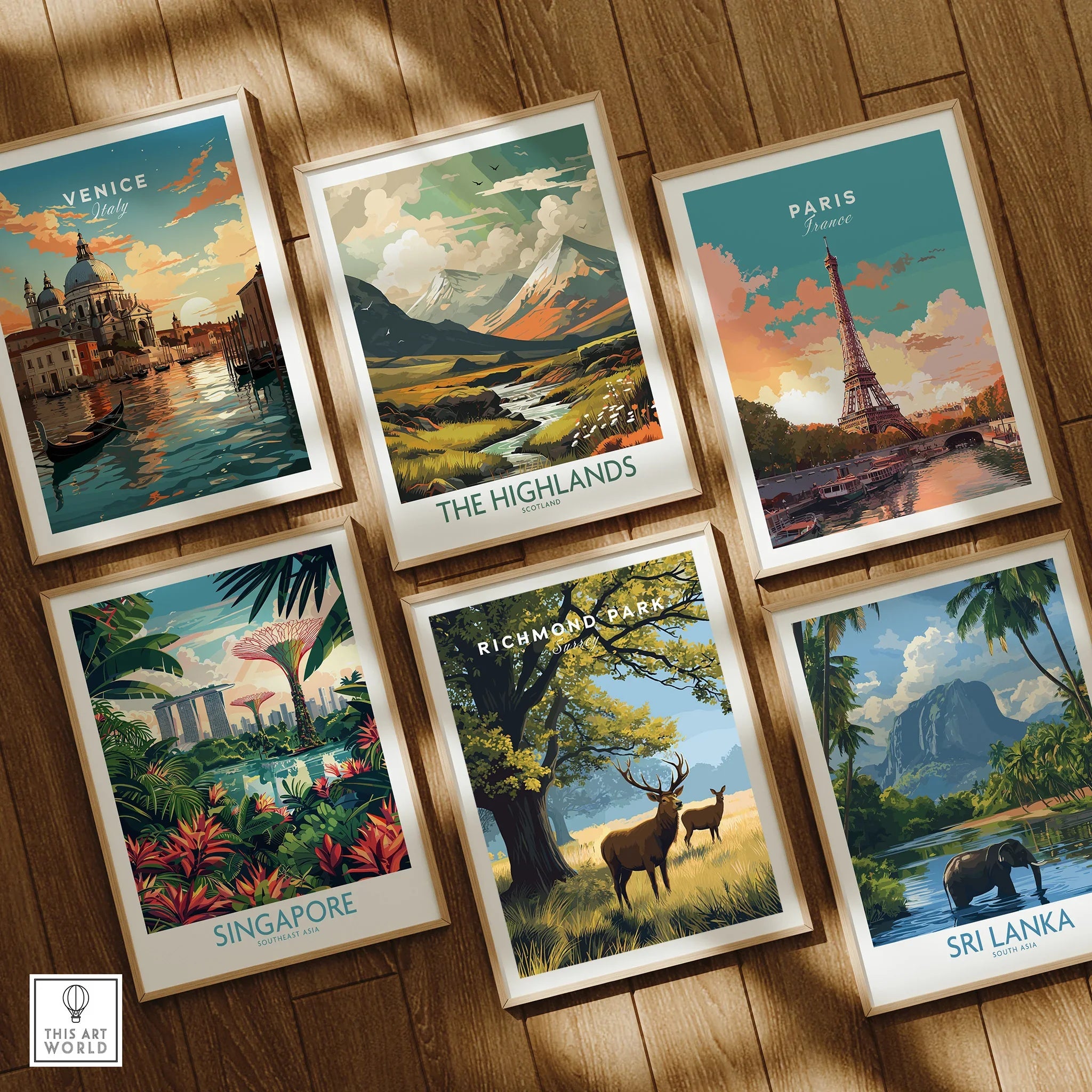 Set of six framed travel art prints with natural wood frames on wooden floor, featuring Venice, The Highlands, Paris, Singapore, Richmond Park, and Sri Lanka.