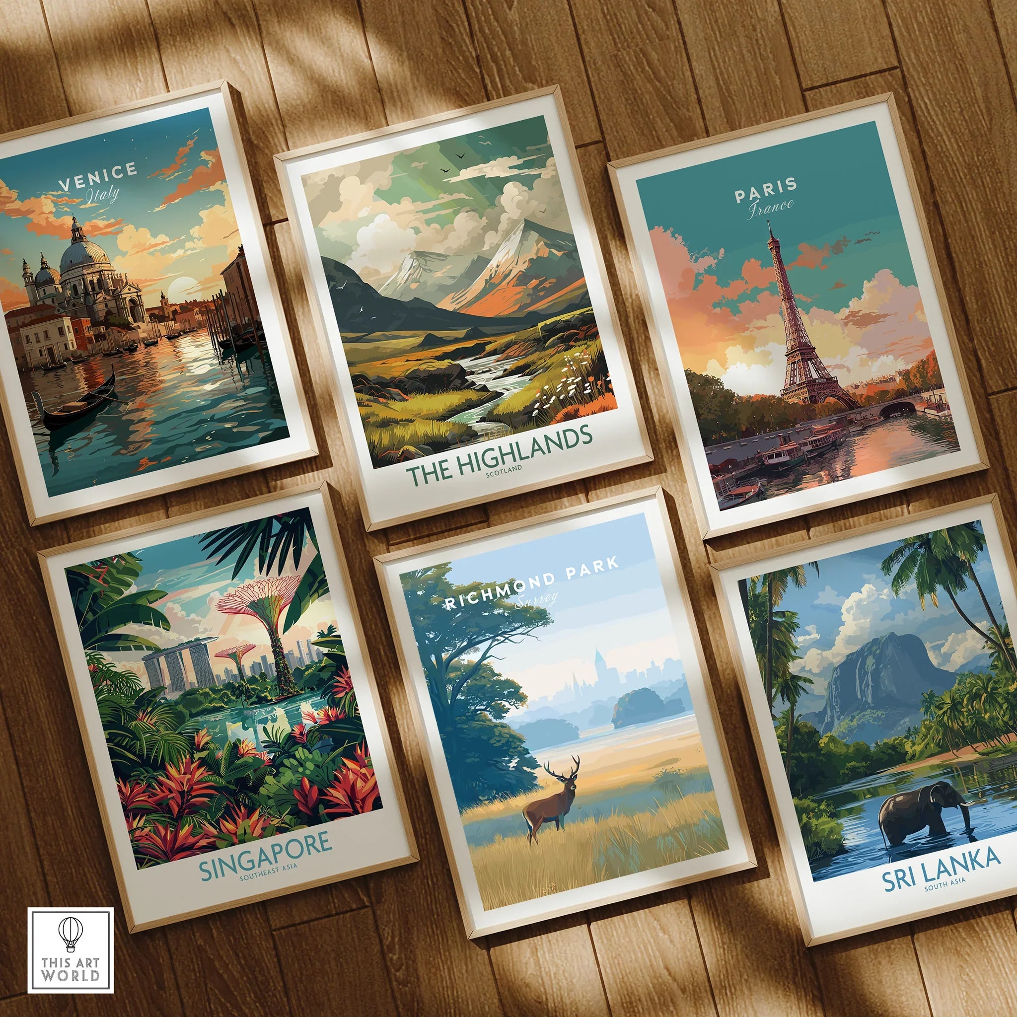 Set of six framed travel art prints featuring Venice, The Highlands, Paris, Singapore, Richmond Park, and Sri Lanka, displayed on a wooden floor.