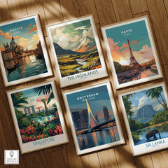 Set of six framed travel posters featuring Venice, Paris, Singapore, Rotterdam, The Highlands, and Sri Lanka on a wooden floor