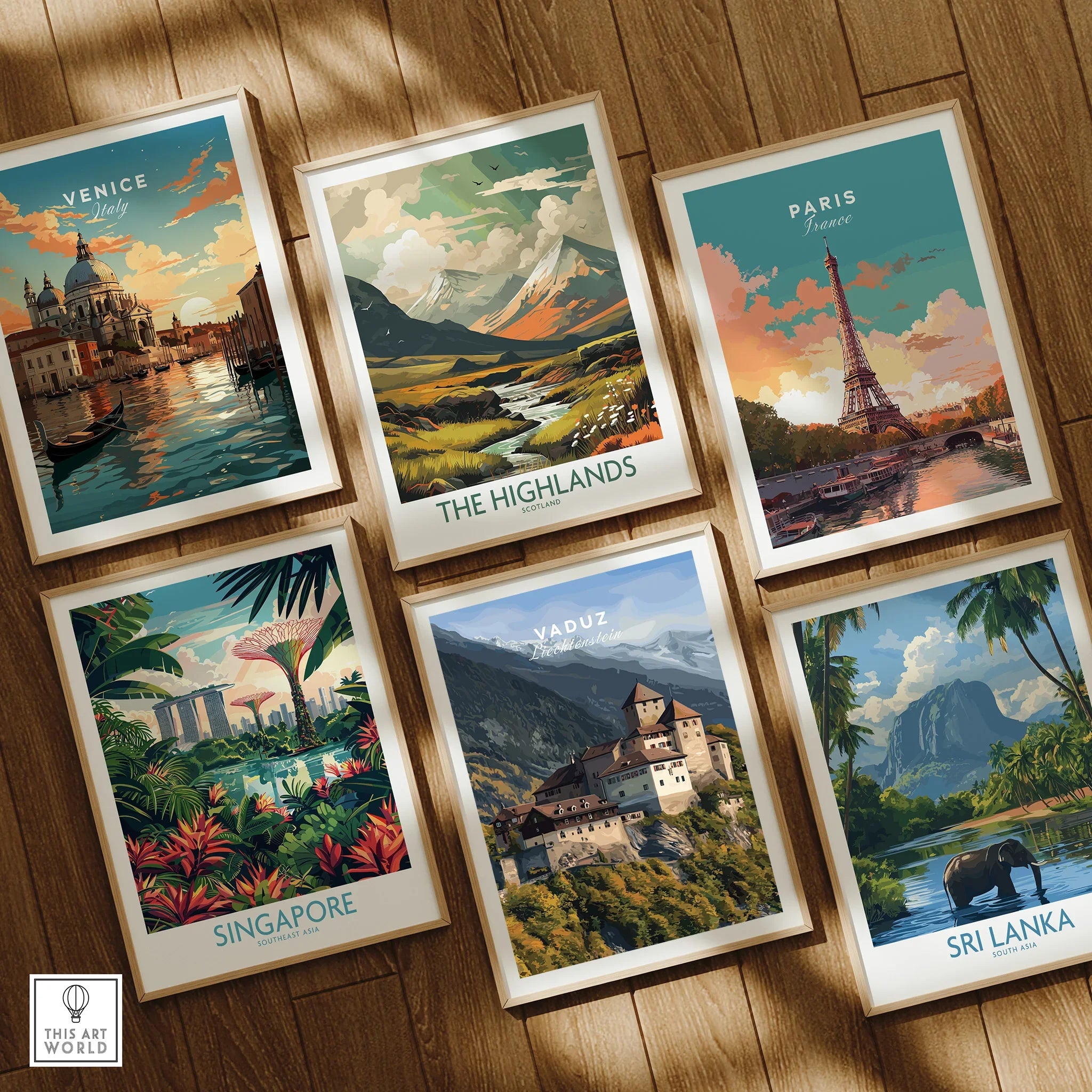 Set of six framed travel posters featuring Venice, the Highlands, Paris, Singapore, Vaduz, and Sri Lanka, displayed on a wooden floor.