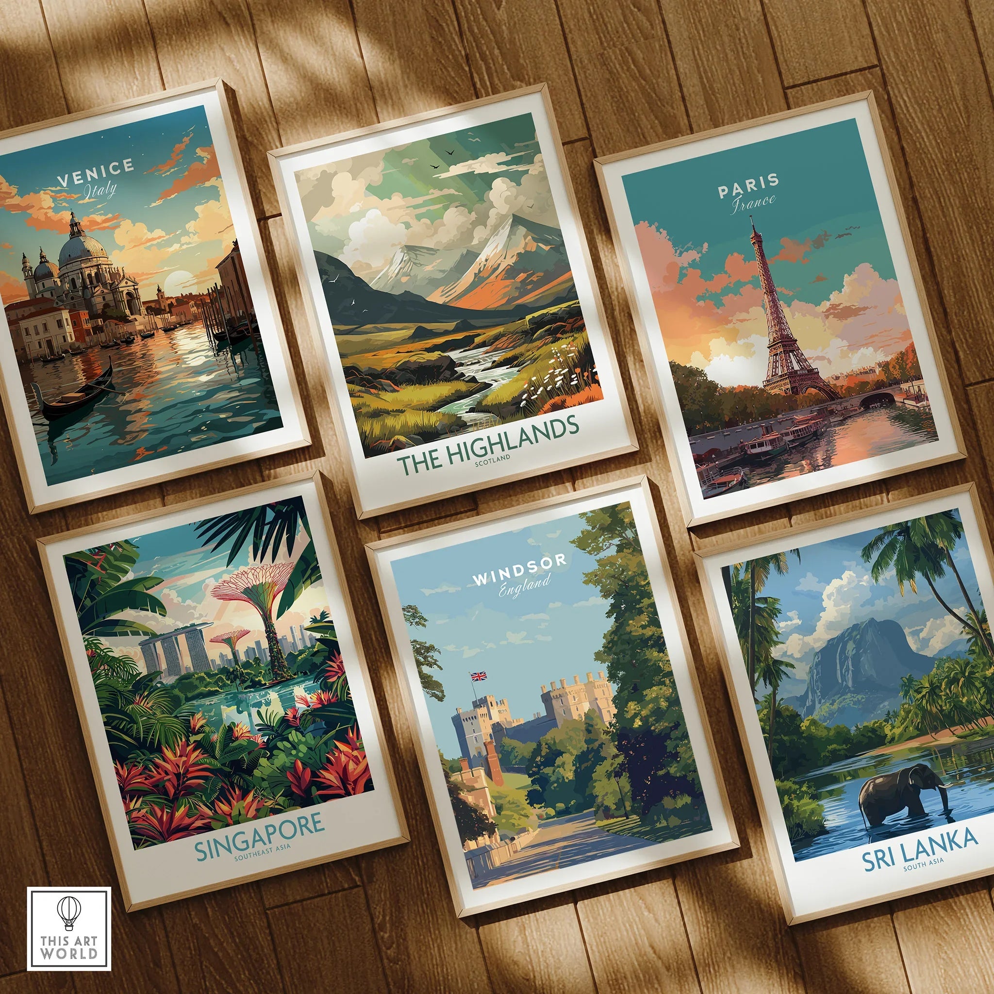 Set of six framed travel posters featuring Venice, Paris, Singapore, Highlands, Windsor, and Sri Lanka, displayed on a wooden floor.