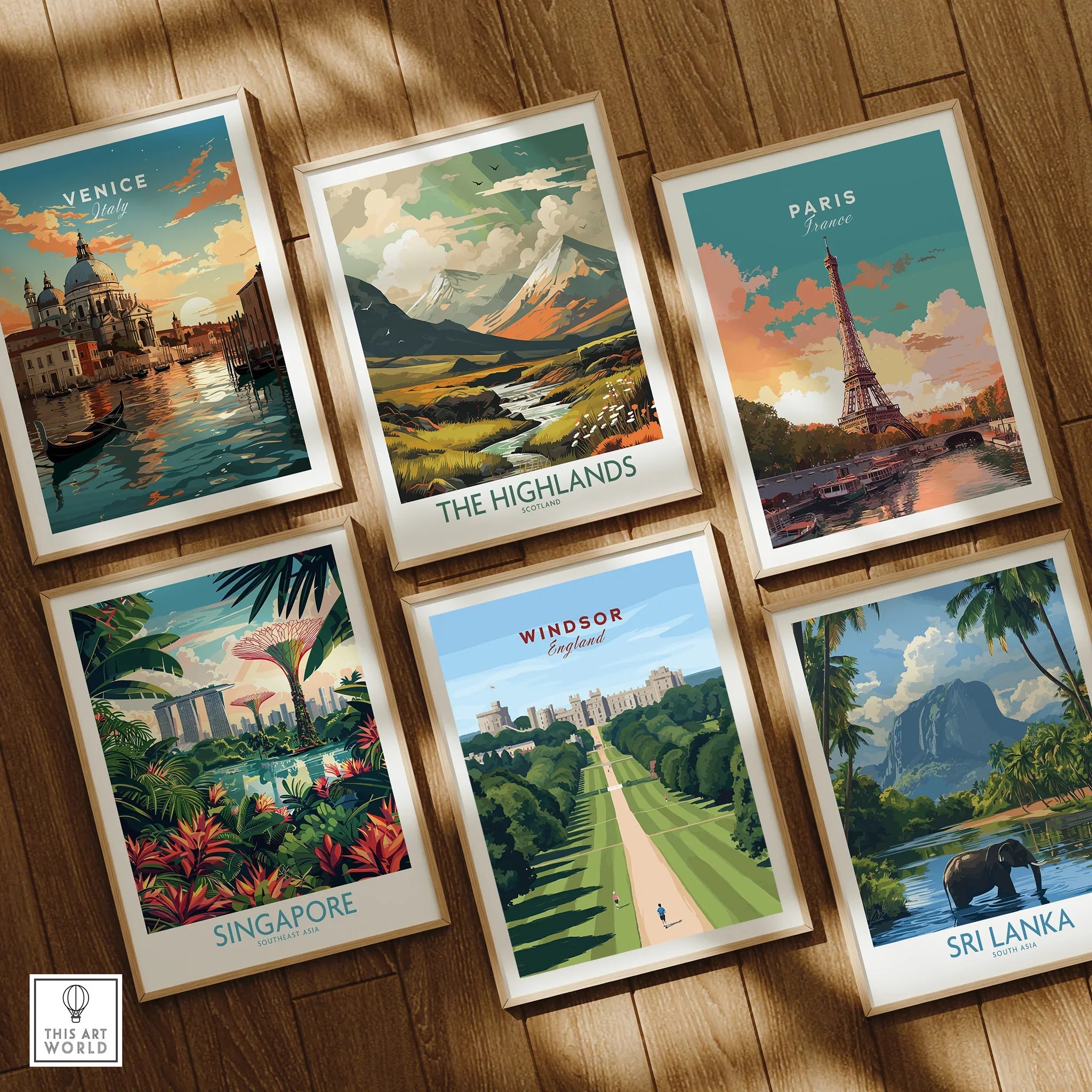 Set of six framed travel posters on wooden floor featuring Venice, Paris, Highlands, Singapore, Windsor, and Sri Lanka.