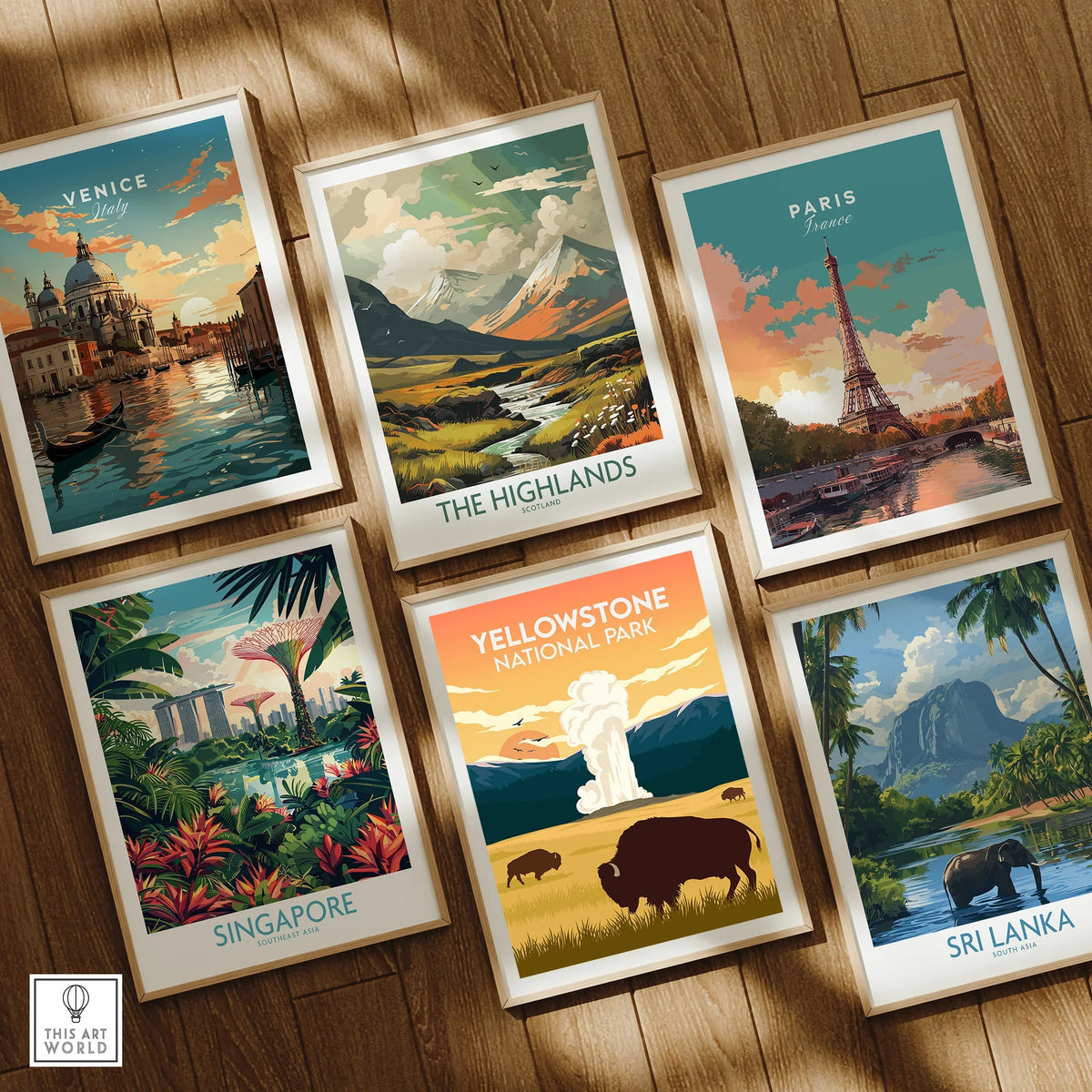 Set of six framed travel posters featuring Venice, Paris, Singapore, Yellowstone, Highlands, and Sri Lanka art prints on wooden floor.