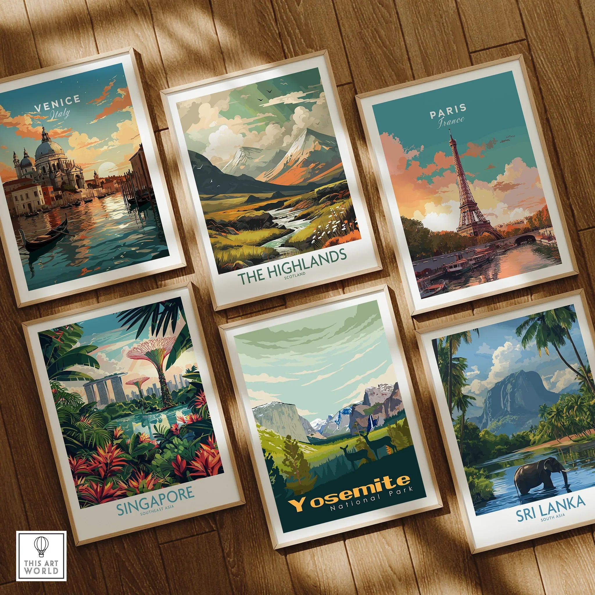 Set of six framed travel art prints featuring Venice, the Highlands, Paris, Singapore, Yosemite, and Sri Lanka, displayed on a wooden floor.