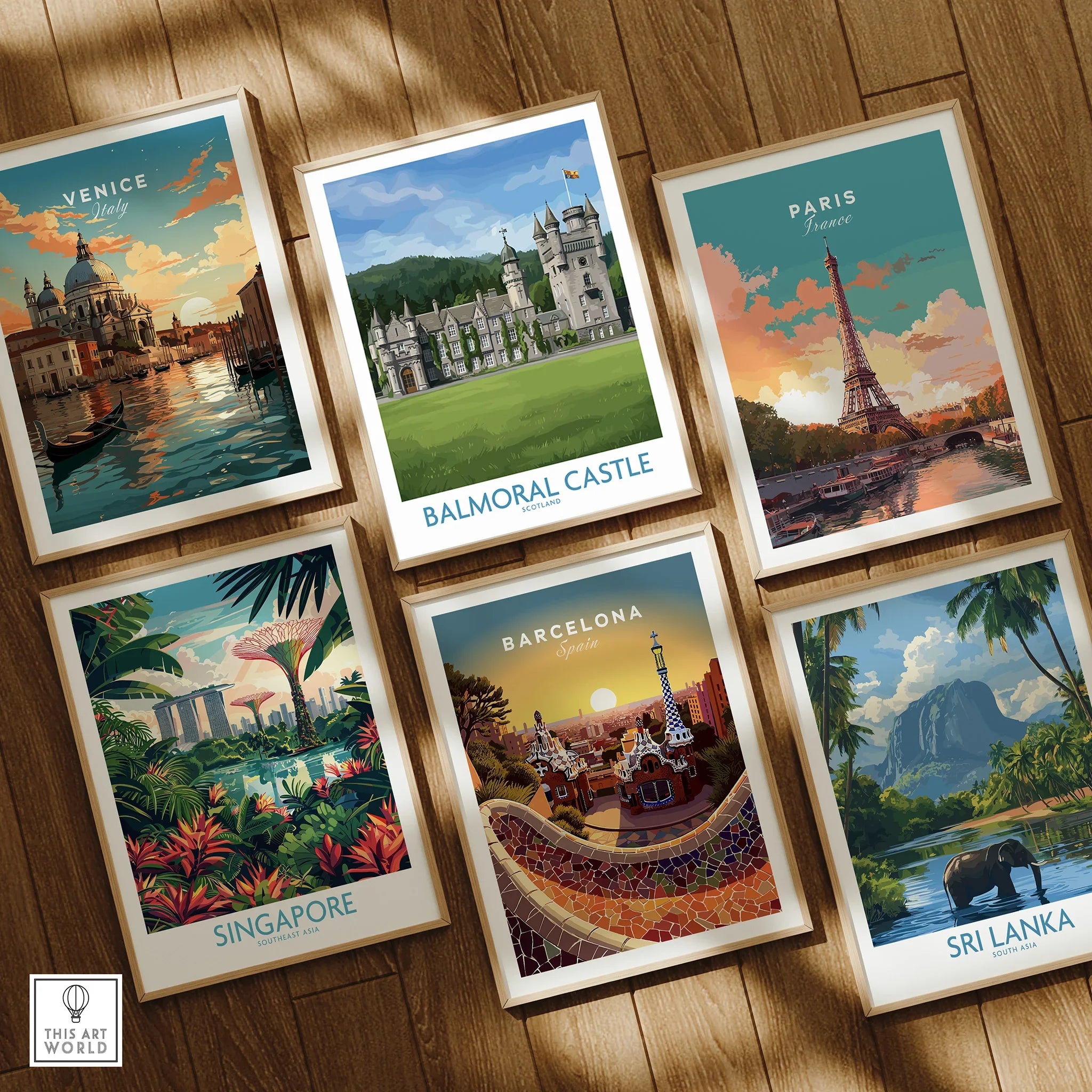 Set of six framed travel and city skyline art prints on wooden floor, featuring Venice, Balmoral Castle, Paris, Singapore, Barcelona, and Sri Lanka.