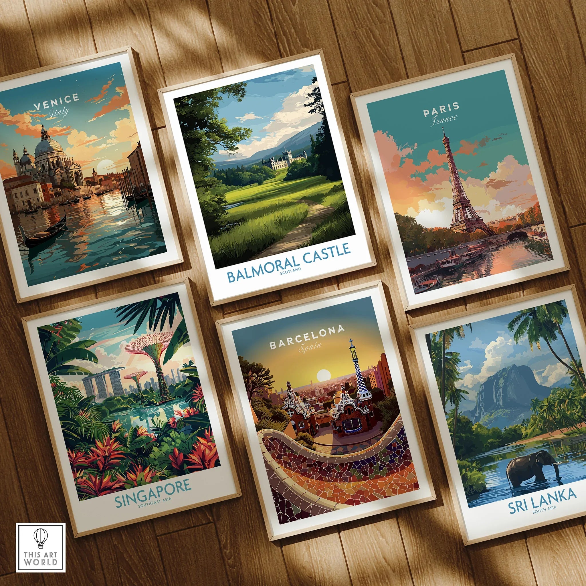 Set of six framed travel posters featuring Venice, Balmoral Castle, Paris, Singapore, Barcelona, and Sri Lanka on wooden floor