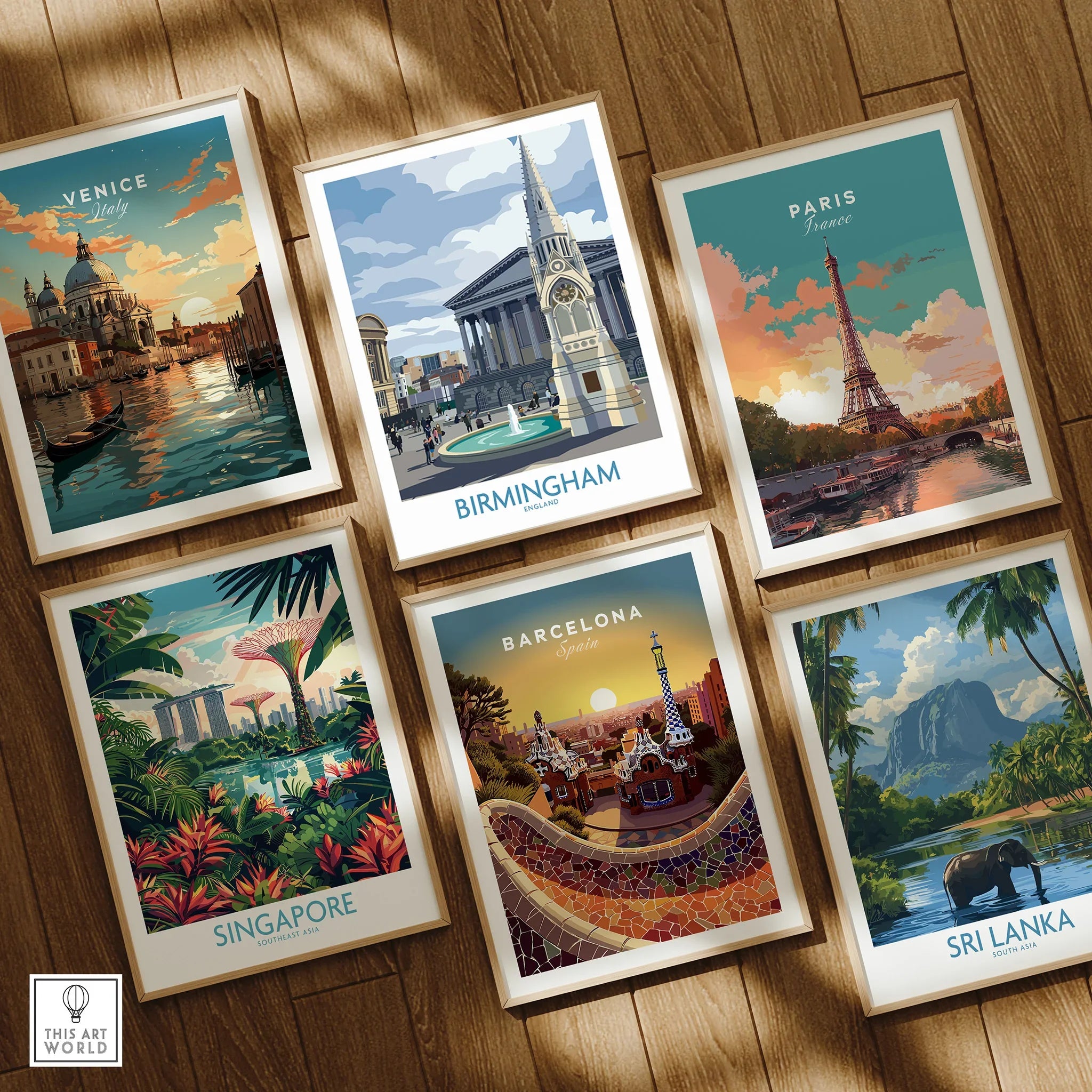 Set of six framed travel posters featuring Venice, Birmingham, Paris, Singapore, Barcelona, Sri Lanka on wooden floor