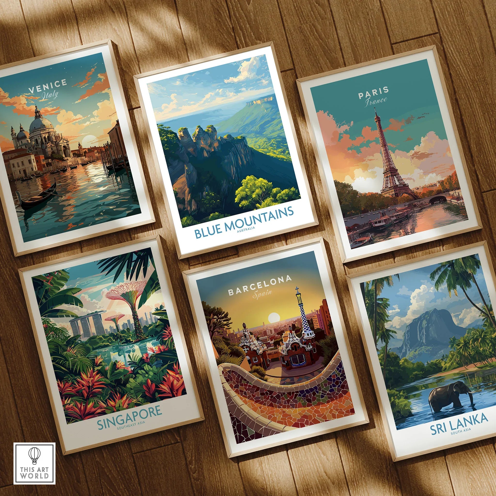 Set of six framed travel posters featuring Venice, Blue Mountains, Paris, Singapore, Barcelona, and Sri Lanka, displayed on natural wood floor.