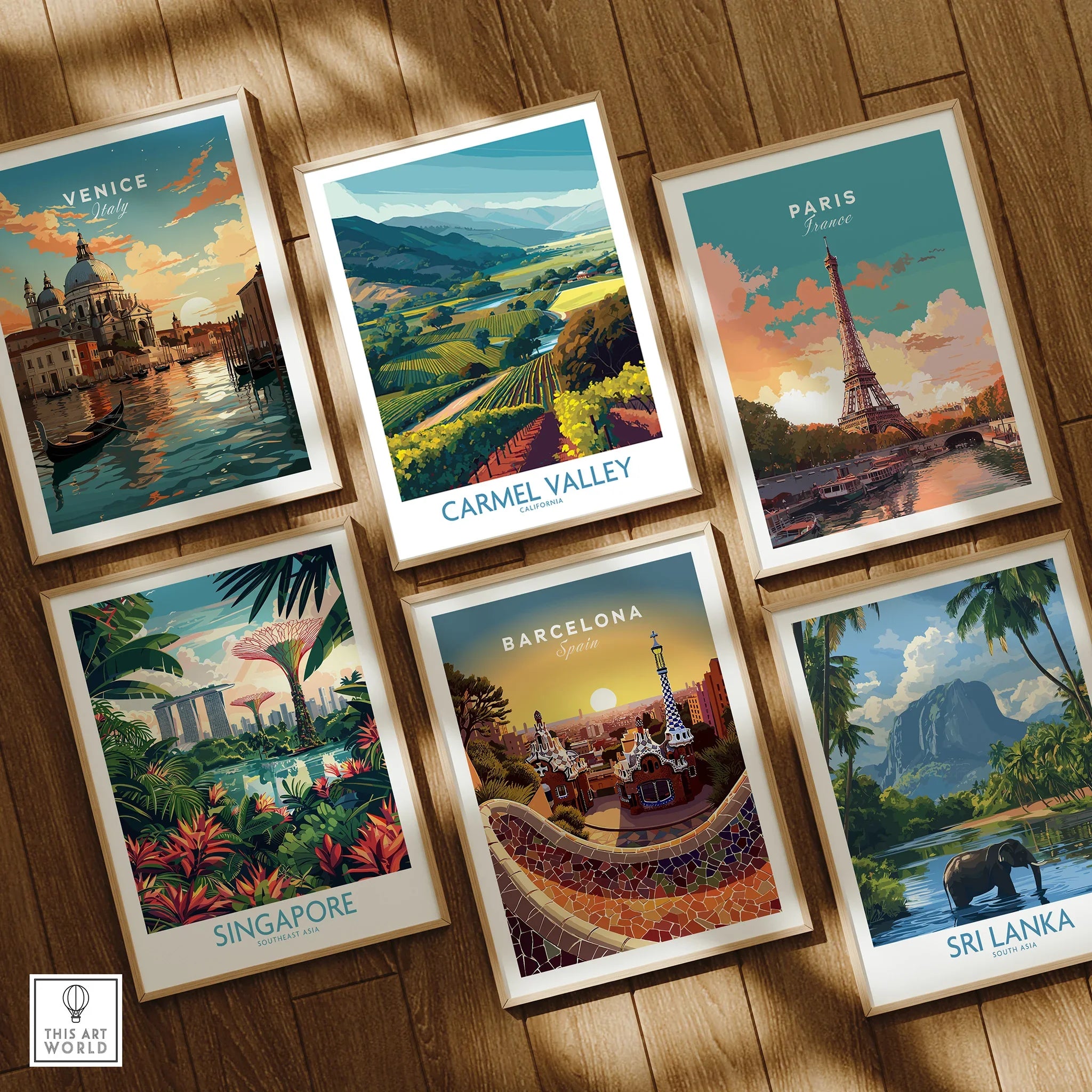 Set of six framed travel posters featuring Venice, Carmel Valley, Paris, Singapore, Barcelona, and Sri Lanka displayed on a wooden floor.