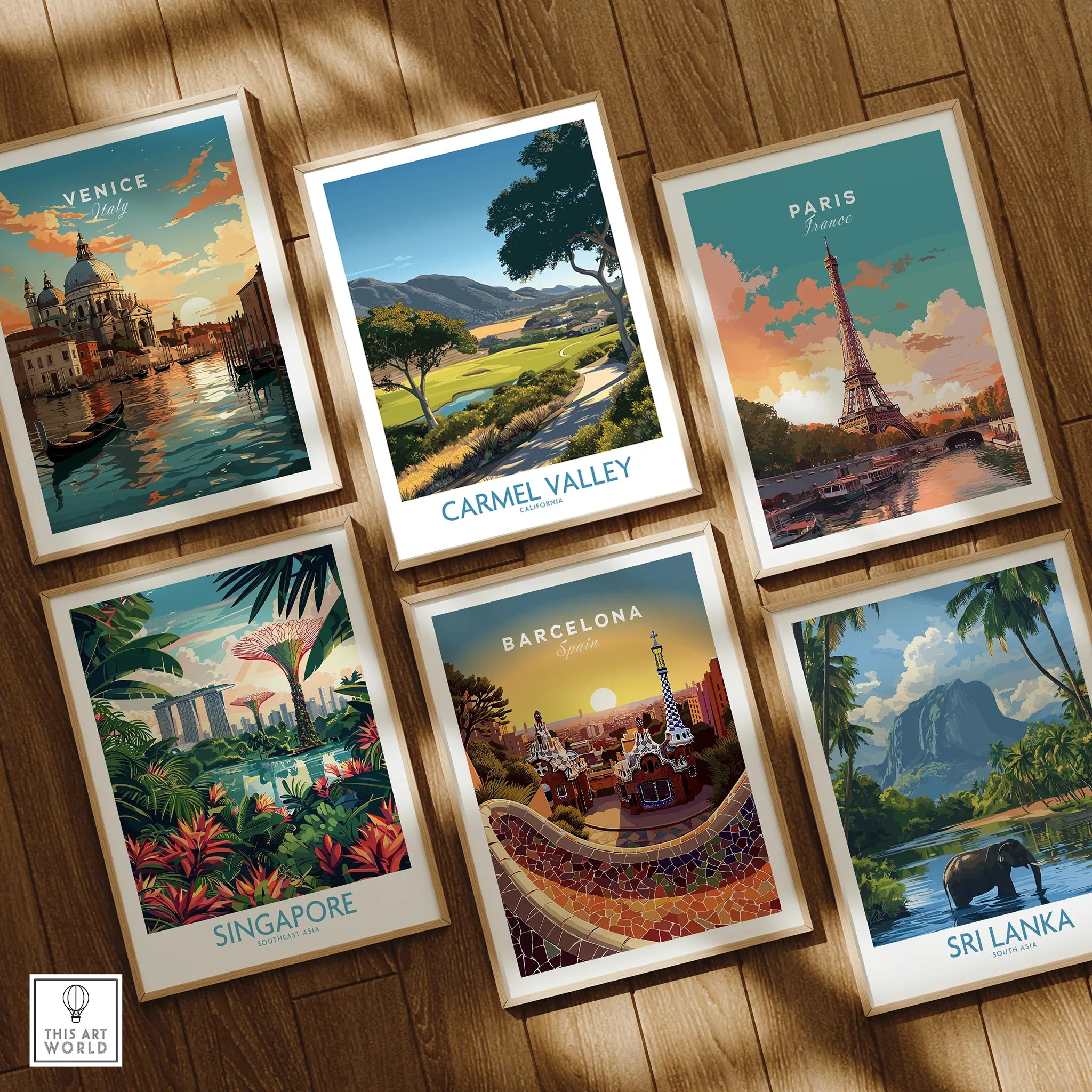 Set of six framed travel posters featuring Venice, Paris, Carmel Valley, Singapore, Barcelona, and Sri Lanka on wooden floor.