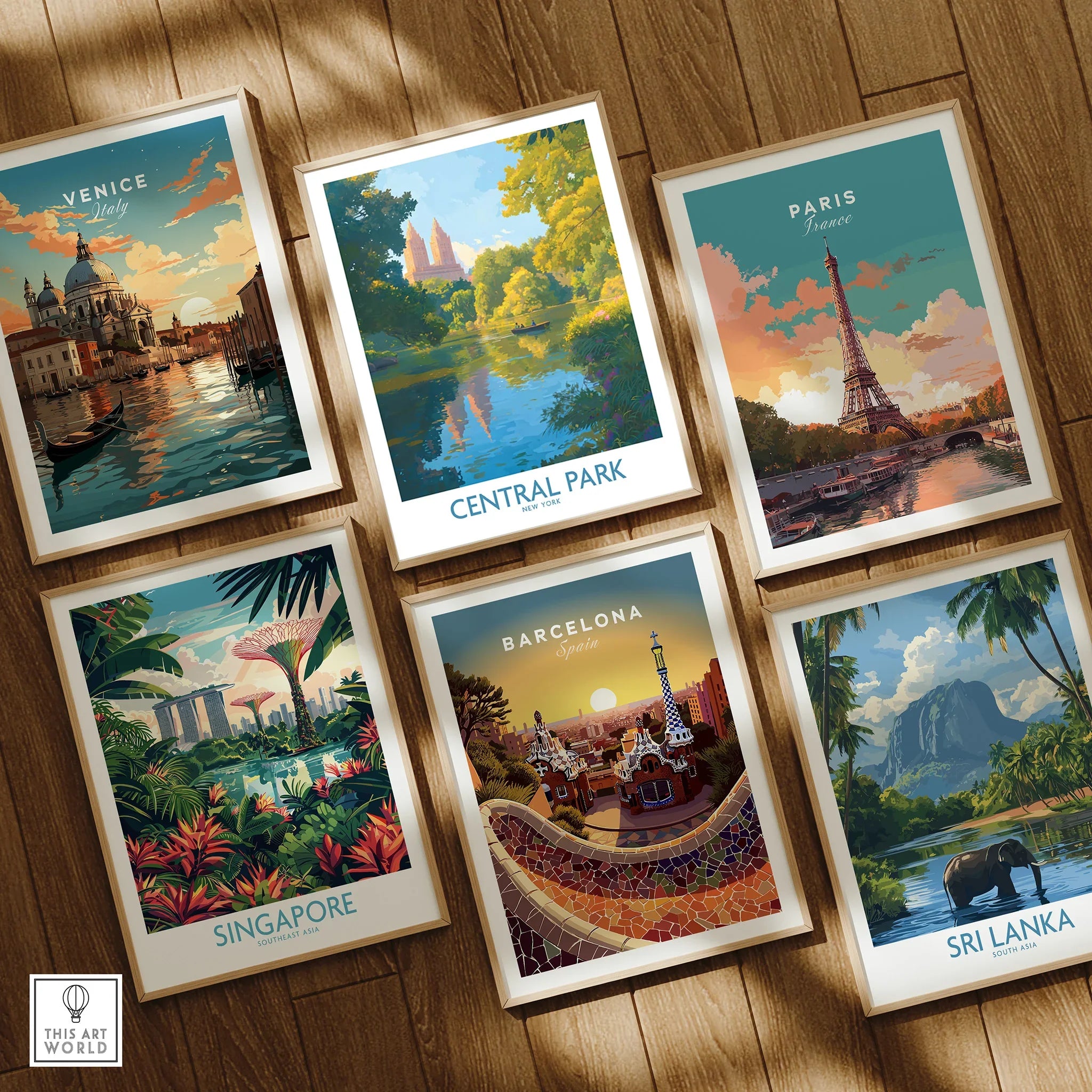 Set of six framed travel posters featuring Venice, Paris, Central Park, Singapore, Barcelona, and Sri Lanka on a wooden floor.