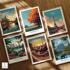Set of six travel poster art prints featuring Venice, Greenwich, Paris, Singapore, Barcelona, and Sri Lanka in natural wood frames on wooden floor.